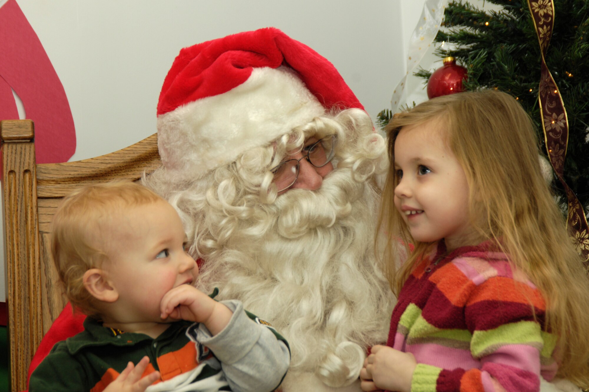 HANSCOM AIR FORCE BASE, Mass. – Joshua (left) and Alyssa Bridges (right) share their holiday wishes with Santa Claus at the Base Chapel on Dec. 3. A large crowd turned out for the base tree lighting ceremony that included a special appearance by Santa Claus.  (U.S. Air Force photo by Linda LaBonte Britt)