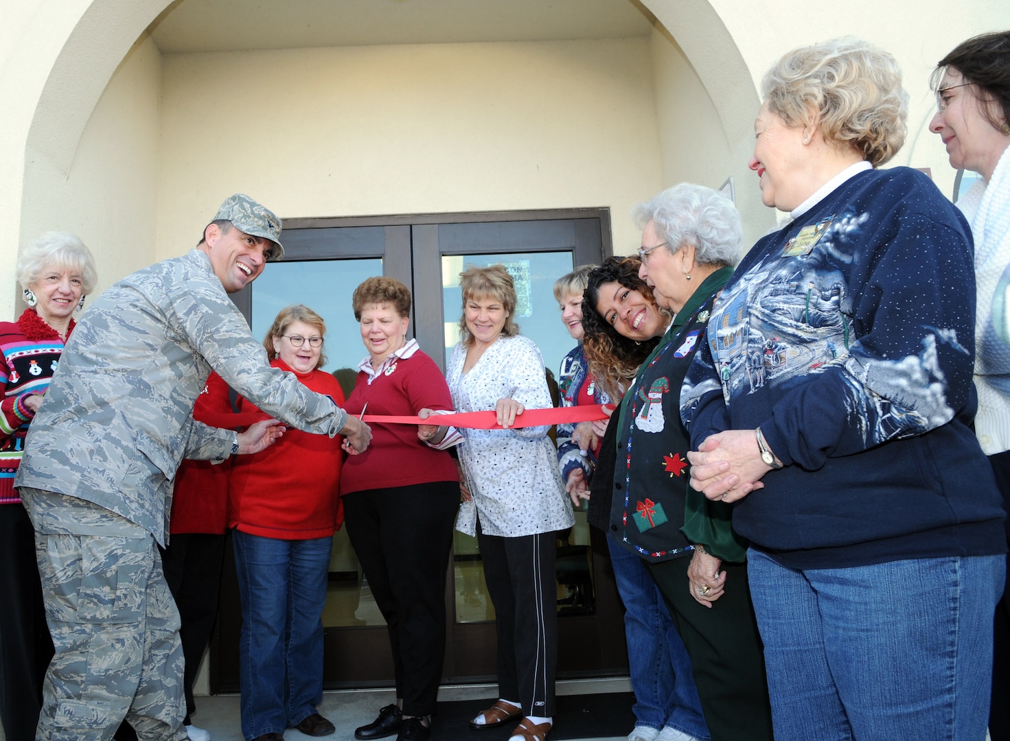 Col. Alan Lake, 12th Mission Support Group commander, cuts the ribbon on the thrift store Dec. 5 at a grand opening ceremony for the new location. (U.S. Air Force photo by Rich McFadden)