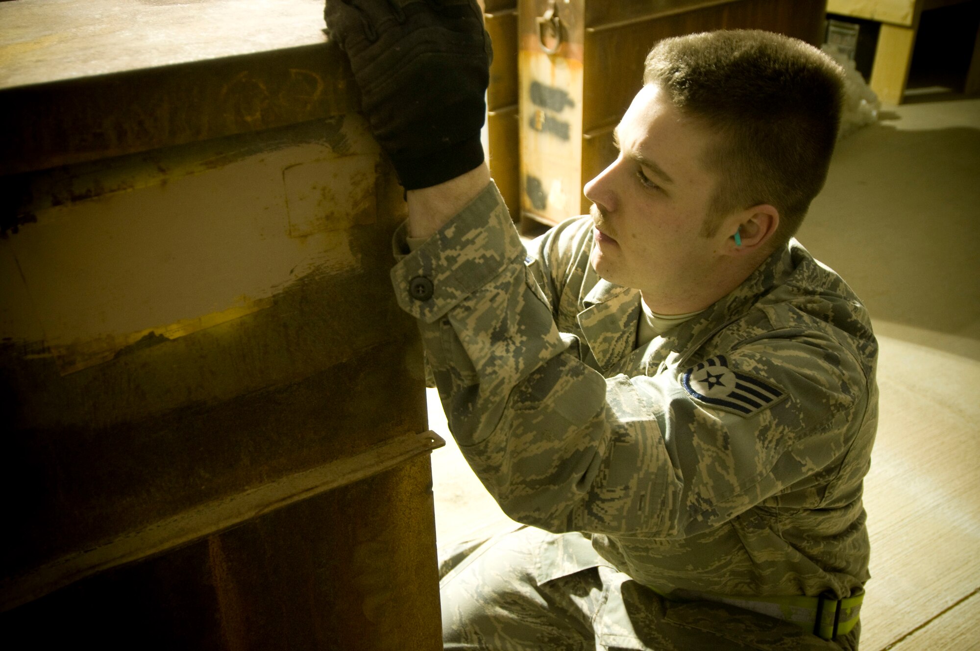 Staff Sgt. Erik Thomas writes the lot number and number of processed rounds on a container at Bagram Air Field, Afghanistan, Dec. 2. These highly explosive rounds must be carefully tracked to ensure total accountability. Sergeant Thomas is deployed from Mountain Home Air Force Base, Idaho, and hails from Bennington, Vt. (U.S. Air Force photo by Staff Sgt. Samuel Morse)(Released)