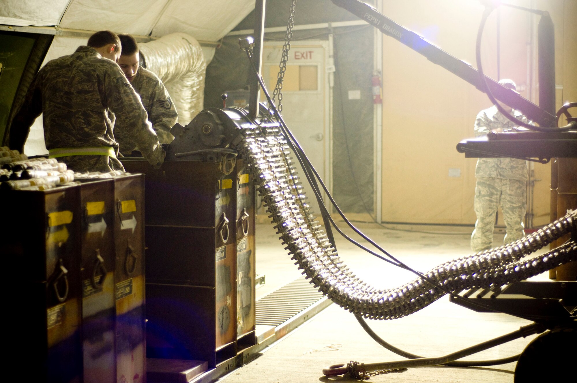 Airmen of the 455th Expeditionary Maintenance Squadron Ammo Flight process and inspect 30mm rounds in a GFU-7 "Dragon" at Bagram Air Field, Afghanistan, Dec. 2. The process also ensures that the right number of rounds go into each canister with no gaps in the chain of linked tube carriers. (U.S. Air Force photo by Staff Sgt. Samuel Morse)(Released)