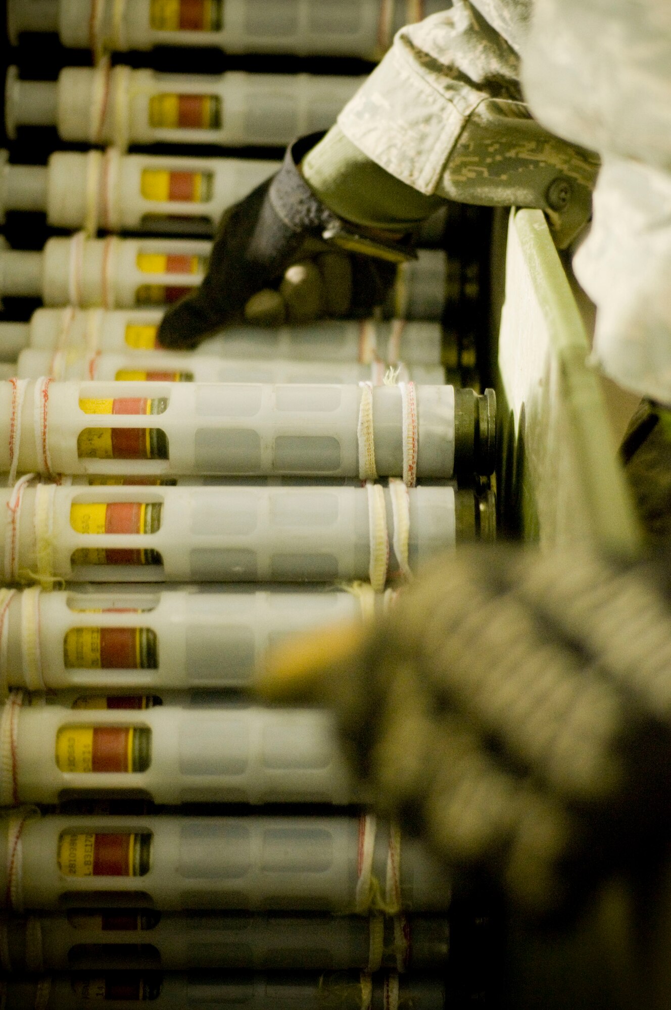 Airman 1st Class Jeb Snow, 455th Expeditionary Maintenance Squadron munitions systems apprentice, guides PGU-13 high-explosive incendiary rounds into the GFU-7 "Dragon" for processing at Bagram Air Field, Afghanistan, Dec. 2. The GFU-7 allows the Airmen to check the rounds and carriers to make sure they're ready to be uploaded to the A-10 Thunderbolt II. Airman Snow is deployed from Mountain Home Air Force Base, Idaho, and hails from Wasilla, Alaska. (U.S. Air Force photo by Staff Sgt. Samuel Morse)(Released)