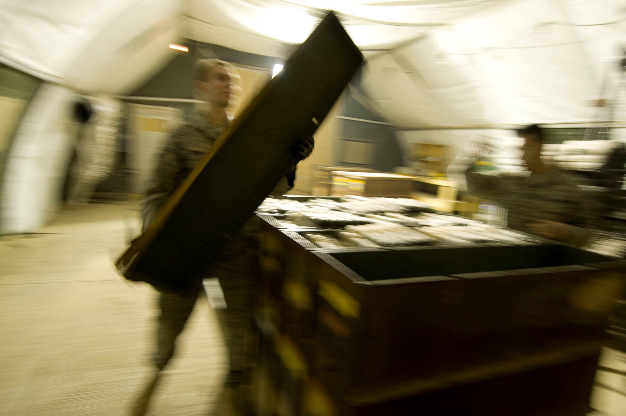 Airman 1st Class Jeb Snow, 455th Expeditionary Maintenance Squadron munitions systems apprentice, removes the lid from an ammo container at Bagram Air Field, Afghanistan, Dec. 2. Airman Snow is deployed from Mountain Home Air Force Base, Idaho, and hails from Wasilla, Alaska. (U.S. Air Force photo by Staff Sgt. Samuel Morse)(Released)