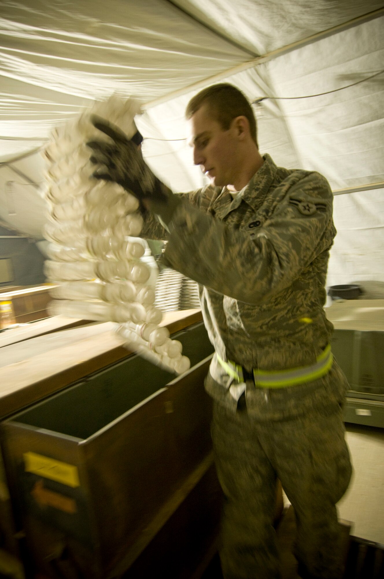 Airman 1st Class Jeb Snow, 455th Expeditionary Maintenance Squadron munitions systems apprentice, prepares linked tube carriers for processing in a GFU-7 "Dragon" at Bagram Air Field, Afghanistan, Dec. 2. Due to the offset of the GFU-7, empty carriers are needed fill the gap. Airman Snow is deployed from Mountain Home Air Force Base, Idaho, and hails from Wasilla, Alaska. (U.S. Air Force photo by Staff Sgt. Samuel Morse)(Released)