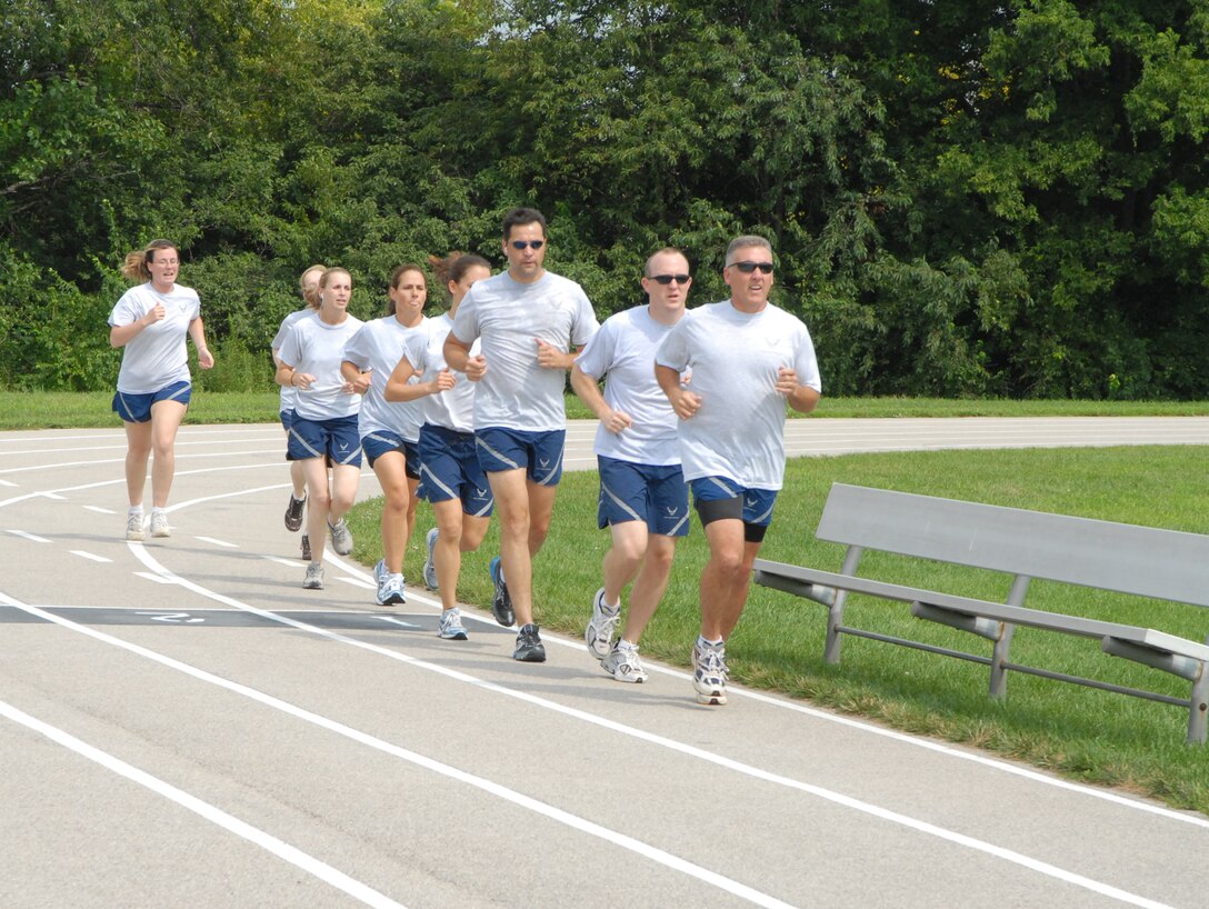 932nd Airlift Wing members follow their commander's example during a "fit to fight" workout session.  Col. John C. Flournoy, Jr., leads the way around the Scott Air Force Base track near Belleville, Ill.  The 932nd AW is an Air Force Reserve Command wing with people participating from 33 different states.  (U.S. Air Force photo/Tech. Sgt. Gerald Sonnenberg)