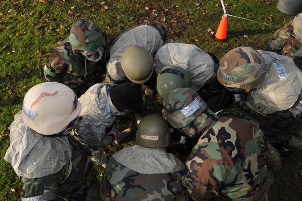 Airman huddle together to learn how to identify M9 detection tape for contamination and the proper procedures on how to correctly set up a controlled area during the “Ability To Survive and Operate” (ATSO) Rodeo at the Main Fitness Center Dec. 5, 2008, in RAF Mildenhall, England. The purpose of the training was to prepare Airman for participation in a Phase 1 and 2 exercise Dec. 8th-12th.  (U.S. Air Force photo by Staff Sgt. Jerry Fleshman)