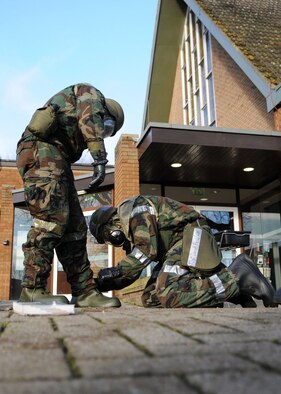 Tech. Sgt. Derek Herd, 100th Communications Squadron, helps a fellow wingman, Airman 1st Class Ronald Greene, from the 100th Maintenance Squadron, with his boots during the ”Ability To Survive and Operate” (ATSO) Rodeo at the Main Fitness Center Dec. 5, 2008, at RAF Mildenhall, England. The purpose of the training was to prepare Airman participating in a Phase 1 and 2 exercise Dec. 8th-12th. Training consisted of hands on self aid buddy care, unexploded ordnance identification and procedures, pre- and post-attack actions, and operating a contamination control area. (U.S. Air Force photo by Staff Sgt. Jerry Fleshman)