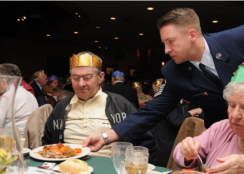 Master Sgt. Matthew Becker from the 100th Maintenance Squadron, serves a hot plate of food to Mr. John Cook from Mildenhall, during the 27th annual Senior Citizens Luncheon Dec. 3, 2008, at RAF Mildenhall, England. Sgt. Matthew’s volunteered as an escort to assist the elderly throughout the event. (U.S. Air Force photo by Staff Sgt. Jerry Fleshman)
