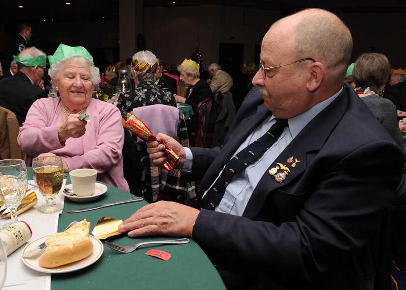 Staff Sgt. Jamie Giekzewski from the 100th Force Support Squadron, lights a candle for the guests during the 27th annual Senior Citizens Luncheon Dec. 3, 2008, in RAF Mildenhall, England. The event is held to give senior citizens in the local area an opportunity to have lunch, play games, and a chance to meet new people. (U.S. Air Force photo by Staff Sgt. Jerry Fleshman)