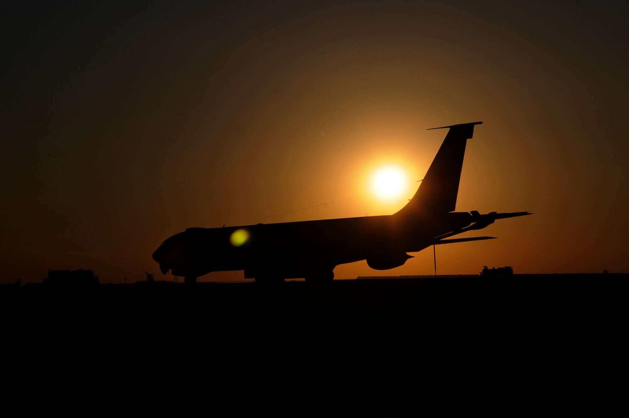 The setting sun silhouettes a KC-135 Stratotanker, Dec. 7, at an undisclosed air base in Southwest Asia.  The KC-135 provides the core aerial refueling capability for the United States Air Force and also provides aerial refueling support to Navy, Marine Corps and allied nation aircraft throughout the Central Command area of responsibility.  (U.S. Air Force photo by Tech. Sgt. Michael Boquette/Released)