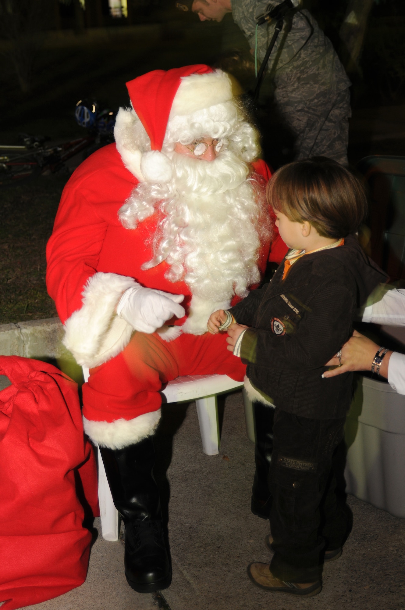 Emry Sparks, 3, tells Santa wat he wants for Christmas this year at the Incirlik Tree Lighting Ceremony Dec. 1. (U.S Air Force photo by Senior Airman Heather Stanton)