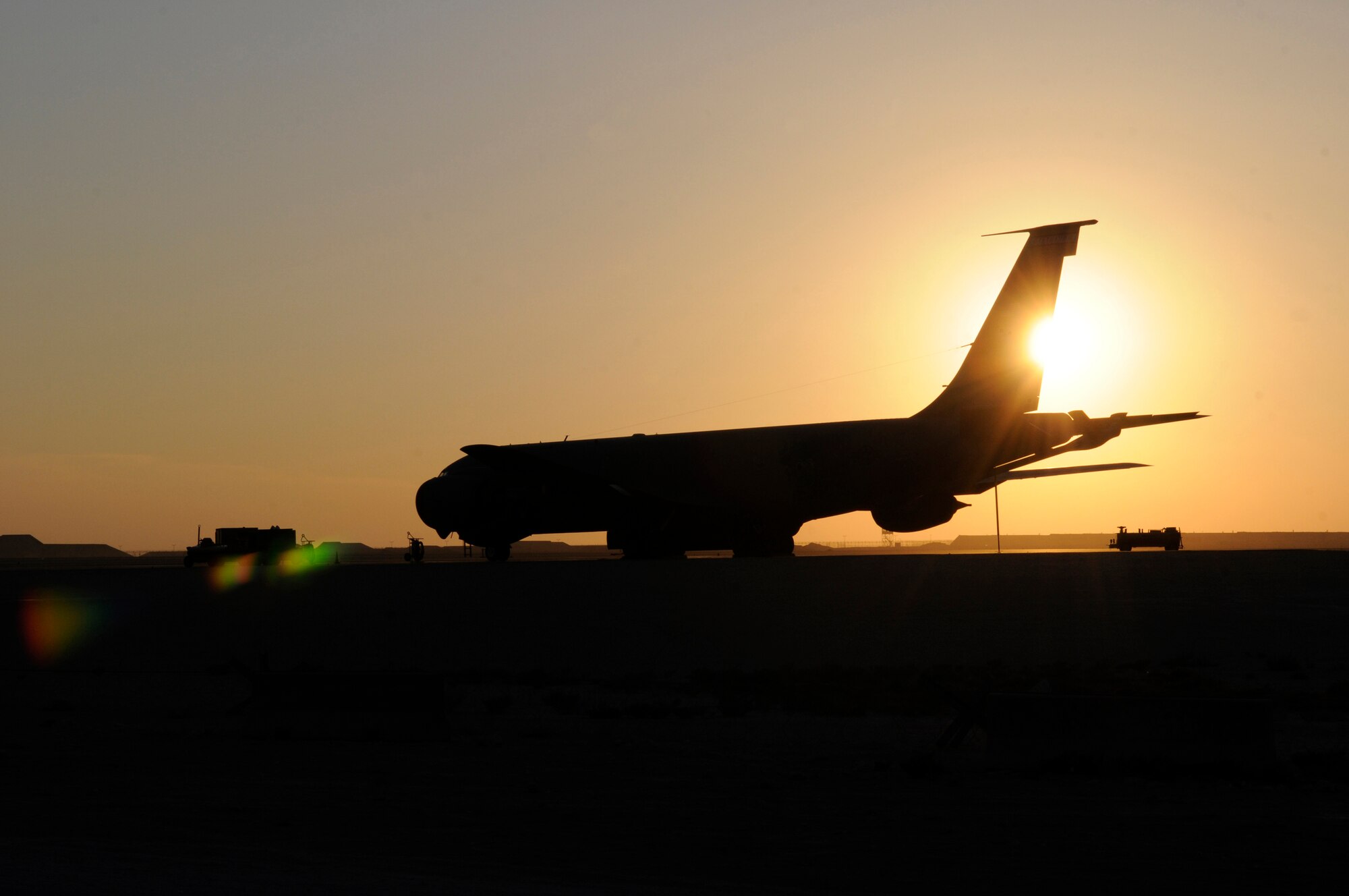 The sun sets on the tail of a KC-135 Stratotanker, Dec. 7, at an undisclosed air base in Southwest Asia.  The KC-135 provides the core aerial refueling capability for the United States Air Force and also provides aerial refueling support to Navy, Marine Corps and allied nation aircraft throughout the Central Command area of responsibility.  (U.S. Air Force photo by Tech. Sgt. Michael Boquette/Released)