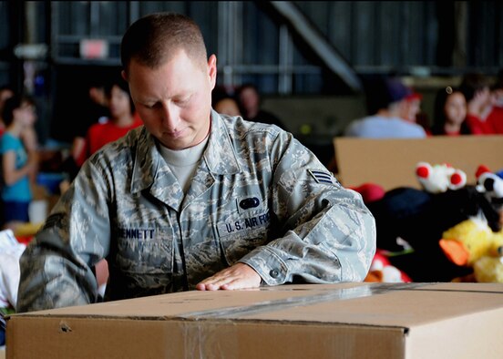 ANDERSEN AIR FORCE BASE, Guam -Senior Airman Craig Bennett, 36th Logistics Readiness Squadron and Operation Christmas Drop Volunteer, prepares a box so it can be filled with goods and supplies here at Hangar 4 Dec. 7. Fishing nets, tools, construction materials, school supplies, shoes, toys and clothing will be dropped in boxes weighing nearly 400 pounds from a C-130 Hercules to aid people of smaller islands that do not have airstrips or major ports. (U.S. Air Force photo by Senior Airman Nichelle Griffiths)