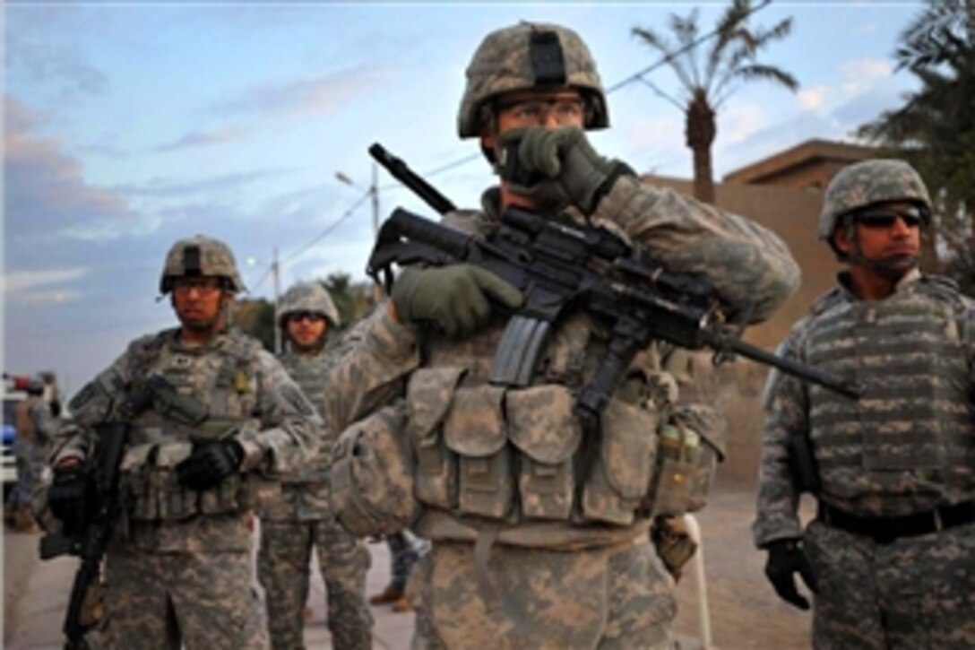 U.S. Army 1st Lt. Justin John checks and organizes his troops during a U.S., Iraqi national police joint patrol and search, Nov. 29, 2008, in the Hadar community of southern Baghdad, Iraq. John is attached to 4th Infantry Division's 2nd Battalion, 4th Infantry Regiment, 1st Brigade Combat Team, Multinational Division Baghdad.