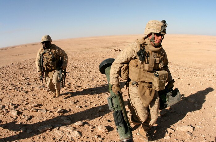 Lance Cpl. Jed Bolyard (right) and Staff Sgt. Terrance James withdraw from their firing position after a successful Javelin missile fire during an exercise near Al Asad Air Base, Iraq, Dec. 8.  Bolyard and James are both with Weapons Company, 2nd Battalion, 25th Marine Regiment, Regimental Combat Team 5.  Marines from Weapons Co. got to participate in an exercise that included air and ground weapons.::r::::n::