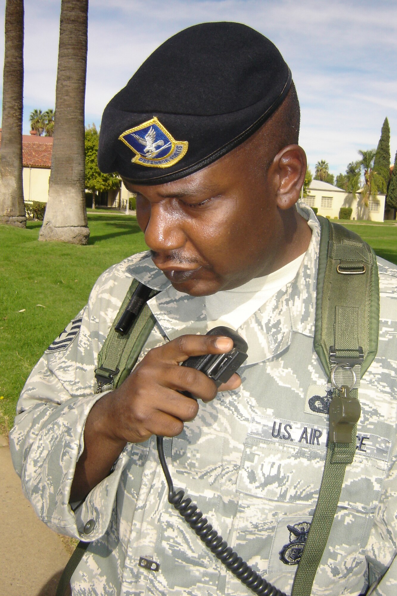 Tech. Sgt. Corinius Hill, 452 SFS, relays a message over the radio at the EOC. (U.S. Air Force photo by Will Alexander)