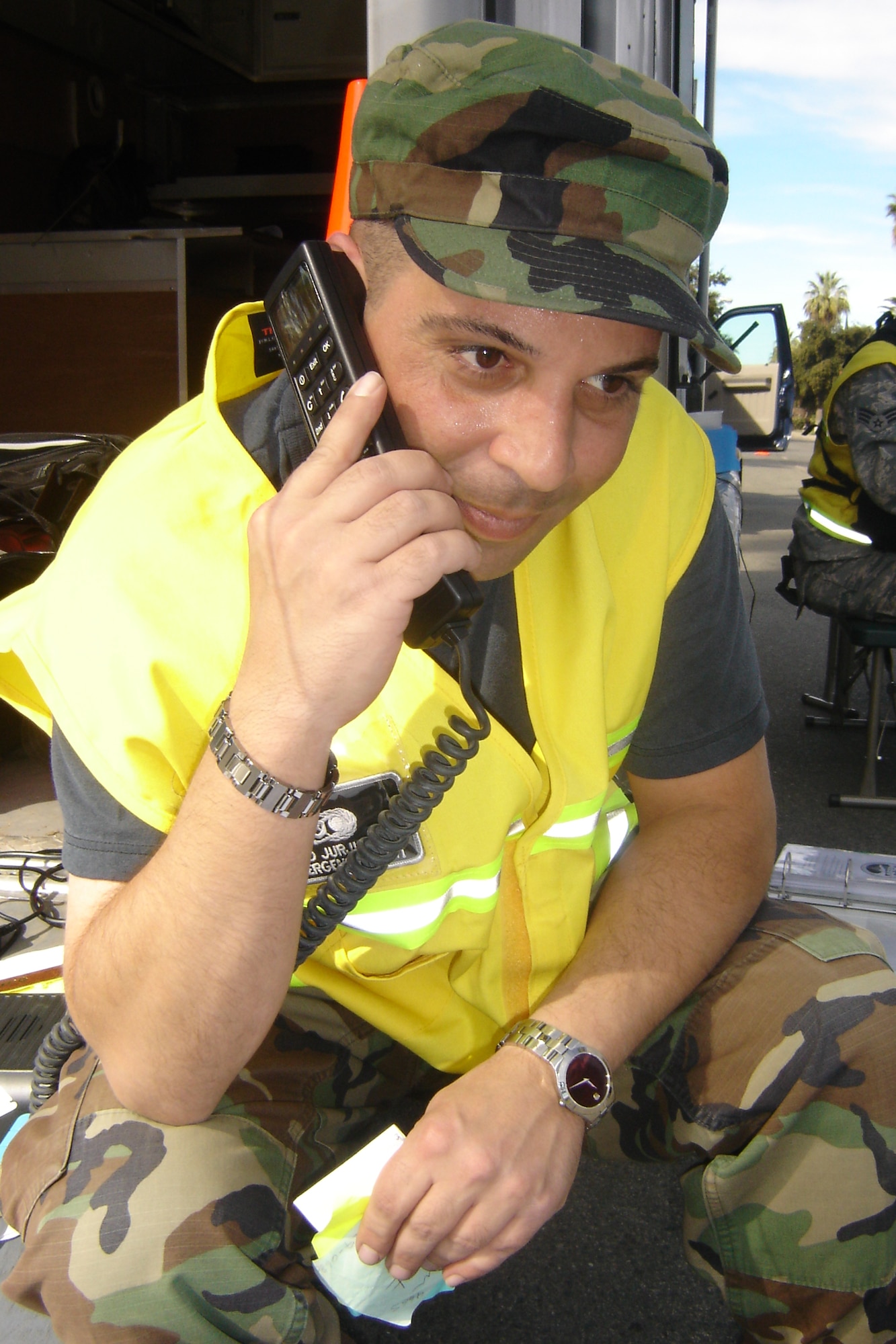 Tech. Sgt. Aiad Jurjis, Emergency Management, attempts to get a connection on a satellite phone. (U.S. Air Force photo by Will Alexander)