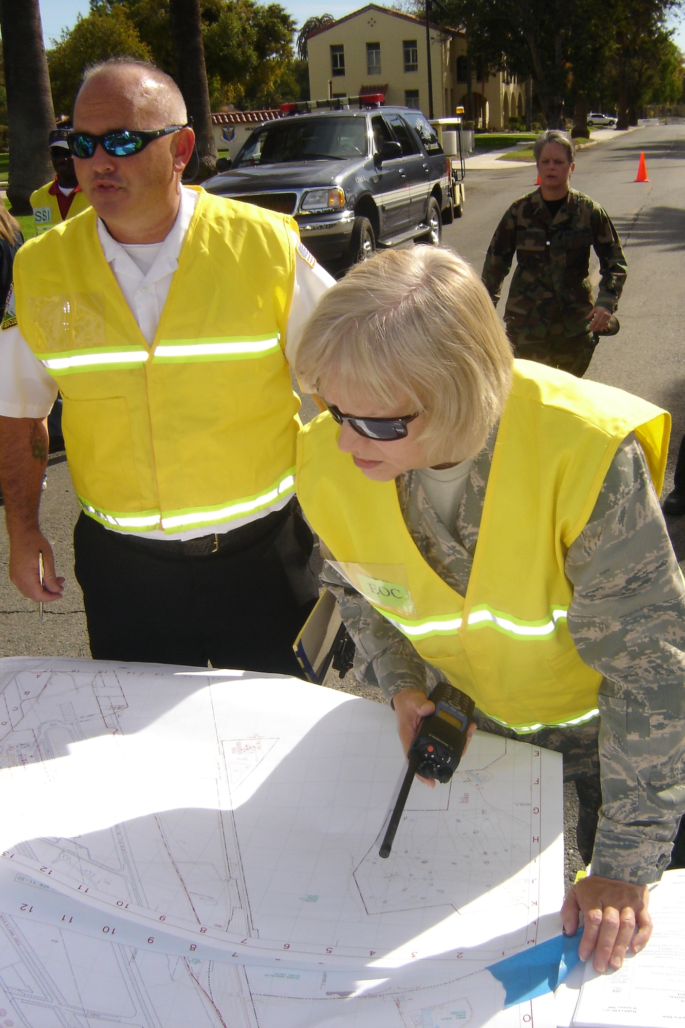 Col. Pamela LeBlanc, 452 MSG commander, and Tim Holliday, deputy fire chief, pore over a map to assess quake damage. (U.S. Air Force photo by Will Alexander)