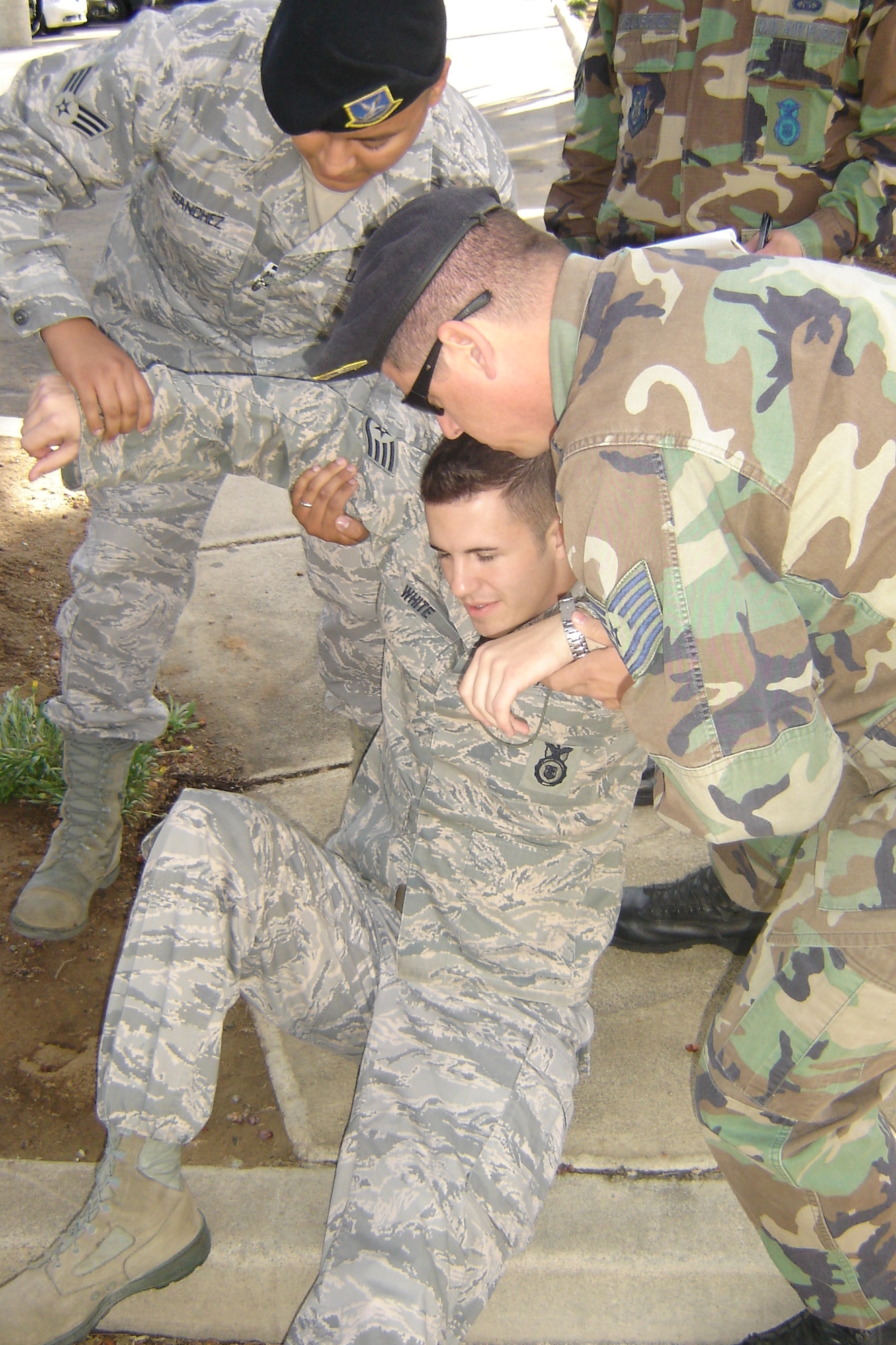 Fellow Airmen evacuate Staff Sgt. Daniel White, 452 AMW/SFS, to a safe area after he’s told he has a fictional leg fracture. (U.S. Air Force photo by Will Alexander)