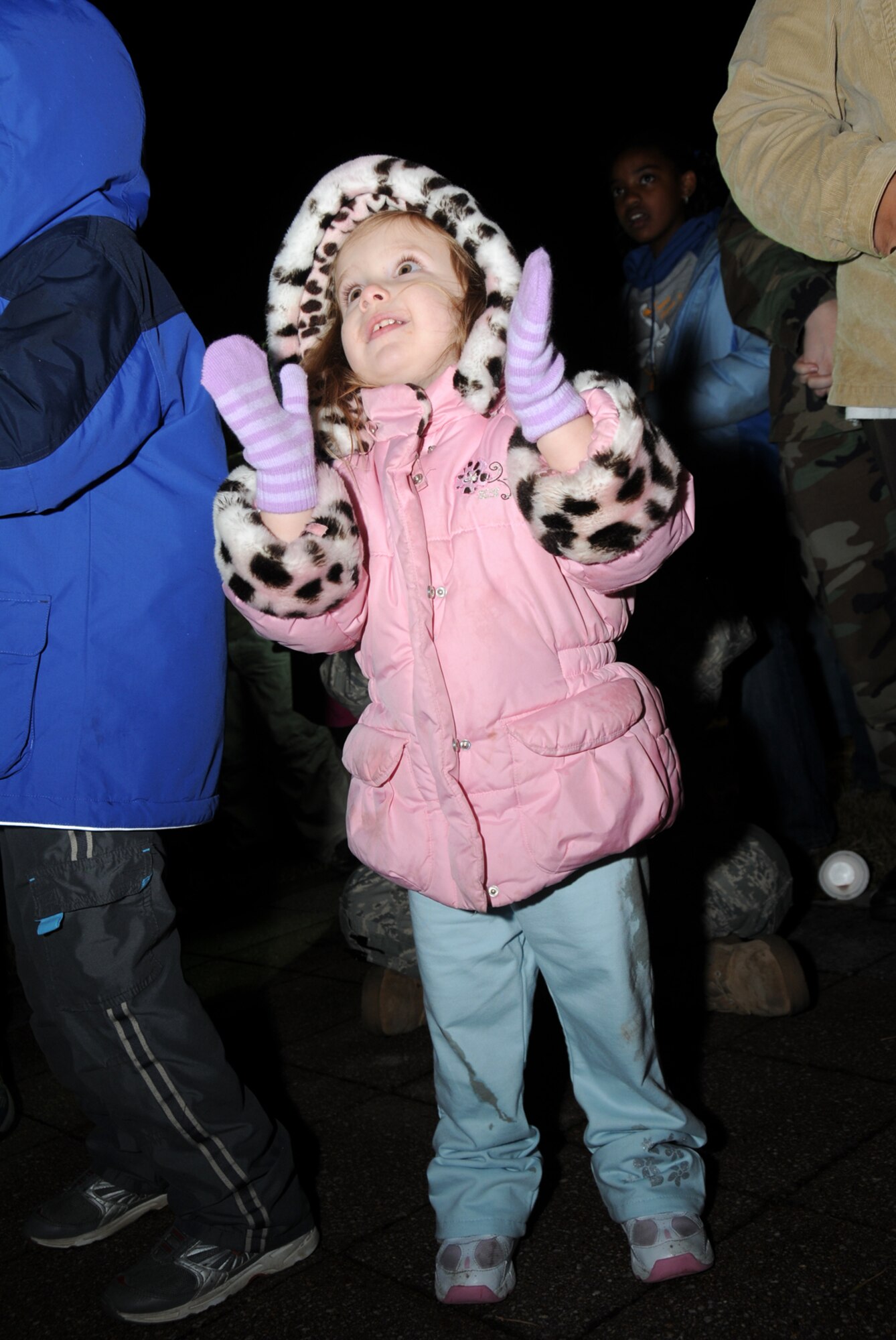 MISAWA AIR BASE, Japan -- Two-year-old Catherine McDaniel, daughter of Capt. Heather McDaniel, 35th Logistics Readiness Squadron, dances to Christmas carols during the annual tree lighting ceremony Dec. 5, 2008. She was one of more than 200 guests. (U.S. Air Force photo by Senior Airman Laura R. McFarlane)