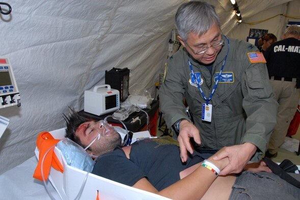 Dr. (Col.) Vincent Dang, 163 MDG, helps to treat a volunteer acting as a trauma victim as part of the California Emergency Medical Services Authority’s annual training event. The training was conducted at March ARB in conjunction with Golden Guardian 2008. (U.S. Air Force photo by Staff Sgt. Diane Ducat)