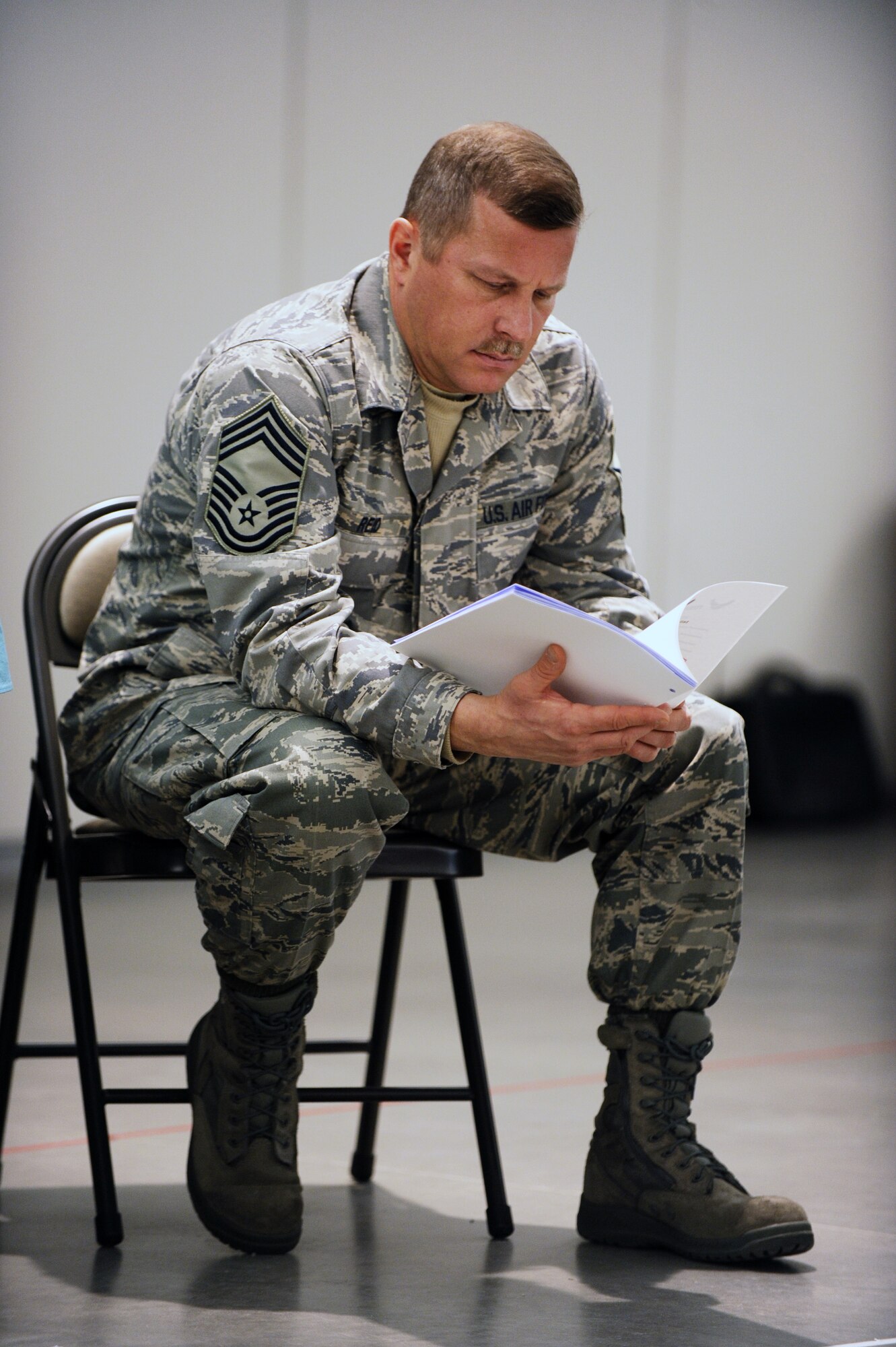 Chief Master Sgt. Blaine Reid looks over the information packet of the wing leadership symposium to discuss the foundation of a new program, Care Teams Wings of Compassion Dec. 5, 2008, at Eielson Air Force Base, Alaska. The program will be designed to setup volunteer staff to assist Air Force families who lost a loved one. Chief Reid is assigned to the 354th Logistics Readiness Squadron.  (U.S. Air Force photo/Senior Airman Jonathan Snyder)