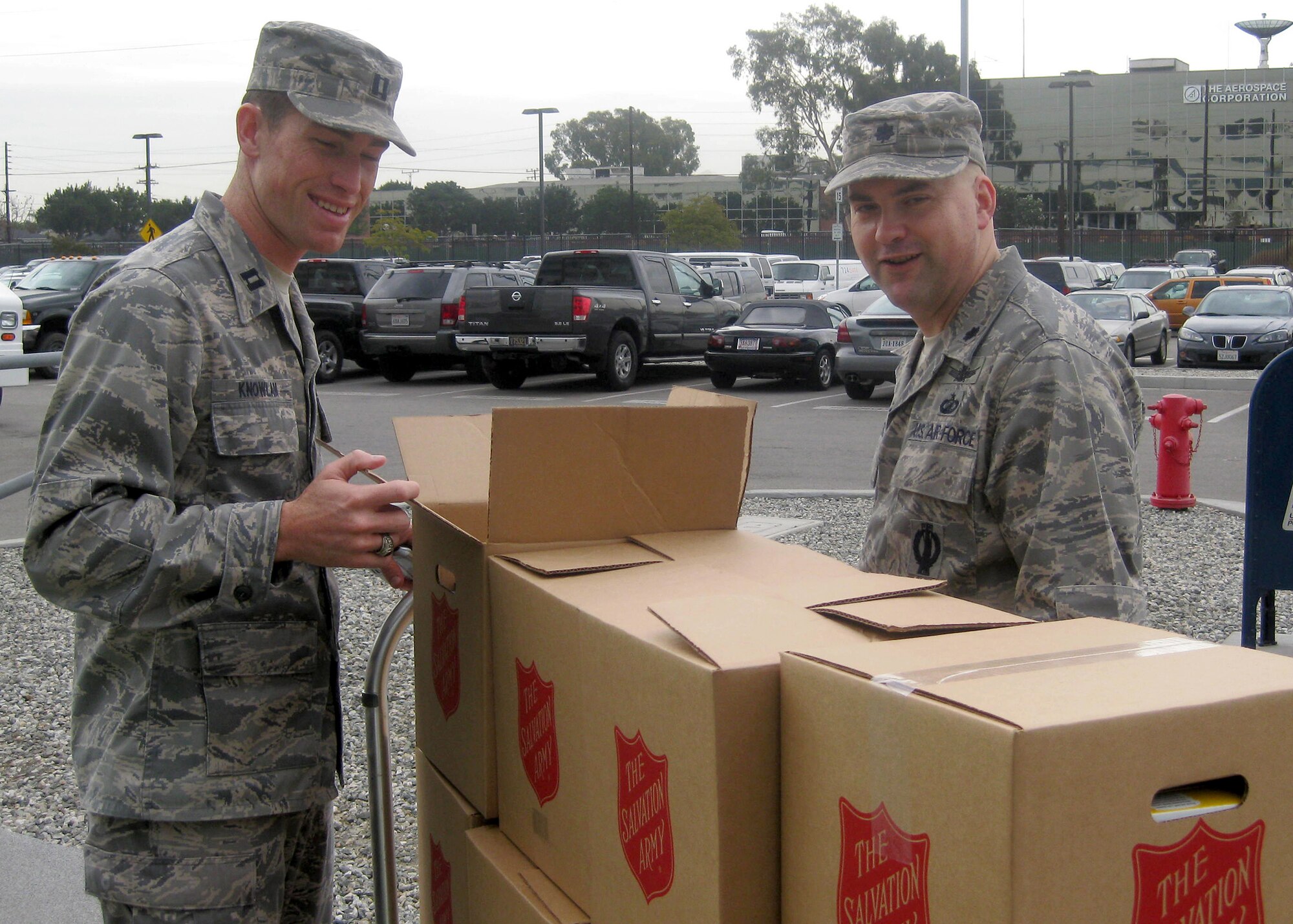 Capt. Garrett Knowlan (left) and Lt. Col. Jon Anderson inspects the boxes full of donated food headed for the Redondo Beach Salvation Army before delivery. (Courtesy photo) 