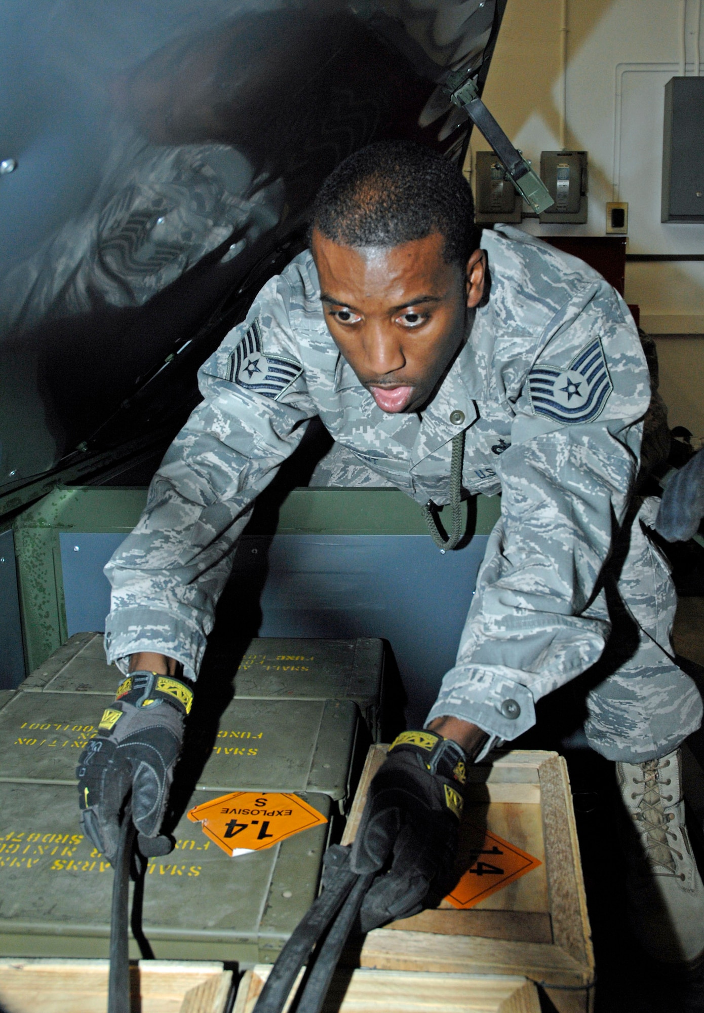 Tech. Sgt. Jason Grant, unit deployment manager for the 88th Security Forces Squadron, loads a shipping container with small arms ammunition at the Wright-Patterson Air Force Base weapons storage area Dec. 5.  Base Airmen participated in a crisis response deployment exercise to send personnel, ammo and equipment to an air base in the U.S. Central Command theater. The exercise is part of base preparations for the 2009 Operational Readiness Inspection. (U.S. Air Force photo/William Pugh) 