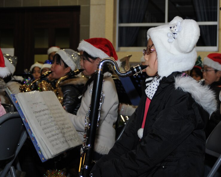 YOKOTA AIR BASE, Japan -- Members of the Hamura City Musashino Elementary School band perform traditional Christmas carols during the annual holiday tree lighting ceremony Dec. 5 at the base chapel.  The ceremony also included an appearance by Santa Claus. (U.S. Air Force photo by Senior Airman Jonathan Fowler)