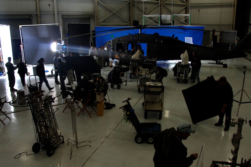 The "Dear John" production crew and Charleston AFB Airmen "wrap up" filming after the last scene was captured inside a hangar on Charleston Dec. 4. Several Charleston Airmen were used during the filming of "Dear John" as extras and subject matter experts for certain required tasks. (U.S. Air Force photo/Senior Airman Timothy Taylor)