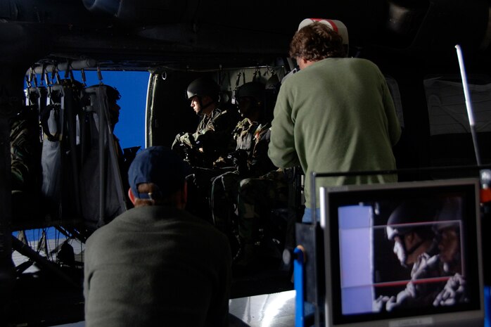 The "Dear John" production crew films in front of a blue screen in a hangar on Charleston AFB Dec. 4. The production company received permission from the Defense Department to use base aircraft, facilities and Airmen to highlight the global airlift mission portrayed in the movie. (U.S. Air Force photo/Senior Airman Timothy Taylor)