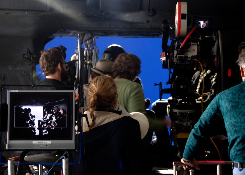 The "Dear John" production crew films a scene in which the main character is airborne in a helicopter in front of a blue screen in a hangar on Charleston AFB Dec. 4. The production company received permission from the Defense Department to use base aircraft, facilities and Airmen to highlight the global airlift mission portrayed in the movie. (U.S. Air Force photo/Senior Airman Timothy Taylor)

