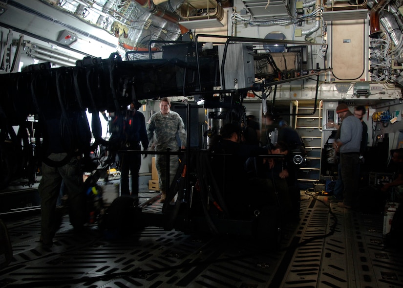 The "Dear John" production crew films a scene inside a C-17 using a telescopic camera crane on Charleston AFB Dec. 4. The production company received permission from the Defense Department to use base aircraft, facilities and Airmen to highlight the global airlift mission portrayed in the movie. (U.S. Air Force photo/Senior Airman Timothy Taylor)