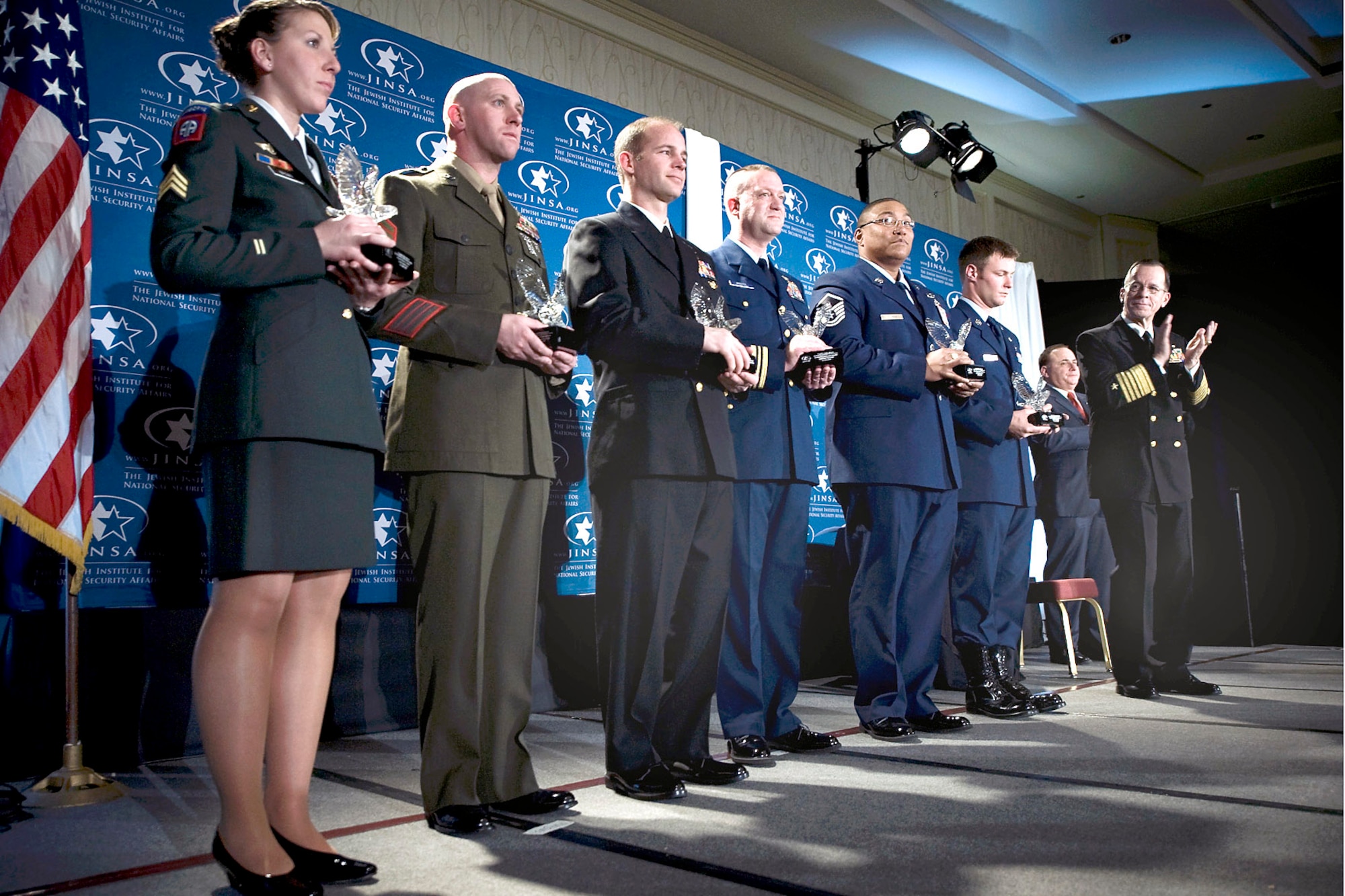 Adm. Mike Mullen, chairman of the Joint Chiefs of Staff applauds in recognition of the six awardees presented the Jewish Institute for National Security Affairs (JINSA) Grateful Nation Award, Crystal City, Va., Dec. 8.  The award recognizes them for having distinguished themselves through superior conduct in the war on terrorism. (Department of Defense photo/Mass Communication Specialist 1st Class Chad J. McNeeley)