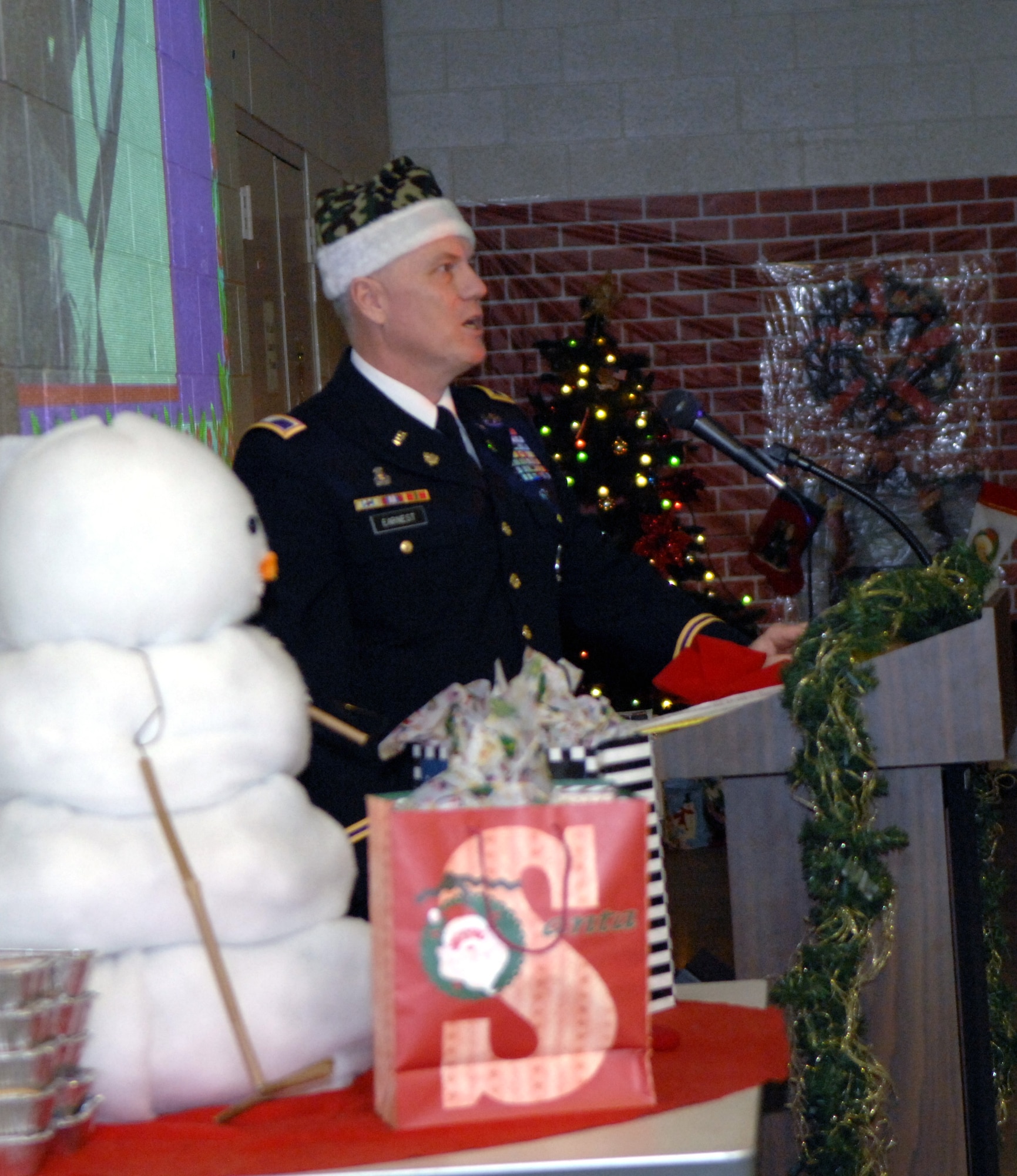 ABILENE, Texas -- Col. Frank Earnest, 490th Civil Affairs Battalion commander, addresses more than 100 unit Reservists and their families at their annual holiday party Dec. 6. This year, the battalion's funding for the party was significantly reduced, so Dyess Airmen volunteered to cook and bring the feast to the Army Reserve Center downtown. “I’m just amazed these guys took the time to do this for us,” Colonel Earnest said. (U.S. Air Force photo/Senior Airman Carolyn Viss)