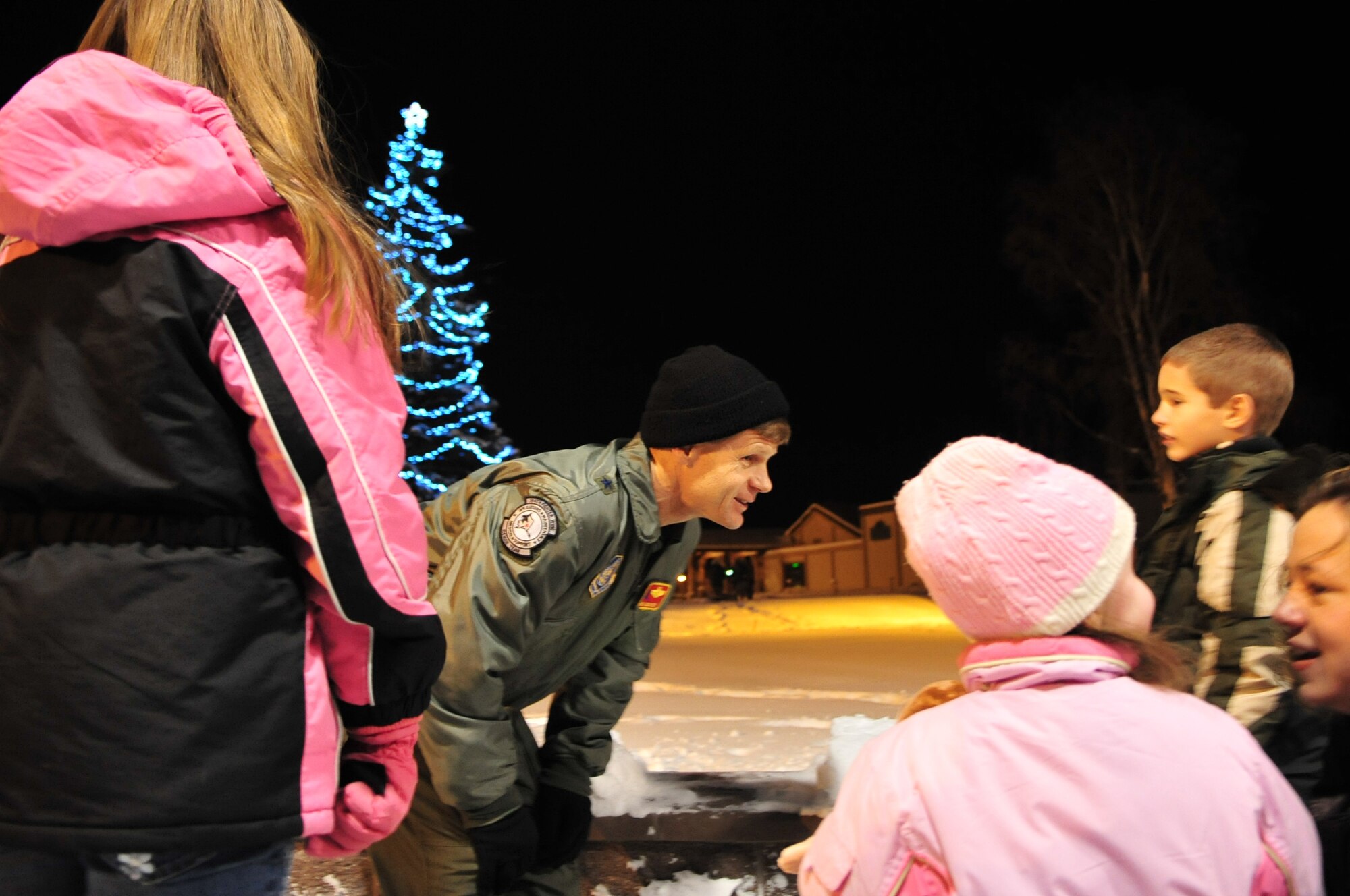 Brig. Gen. Mark Graper, 354th Fighter Wing Commander, reflects with distinguished families Dec. 8 on their experiences lighting the Christmas tree at the first Christmas Tree Lighting Ceremony for the new base Chapel. The families were recognized because of their loved ones? sacrifice to serve away from their families during the holiday season. (U.S. Air Force photo by Airman 1st Class Willard E. Grande II)