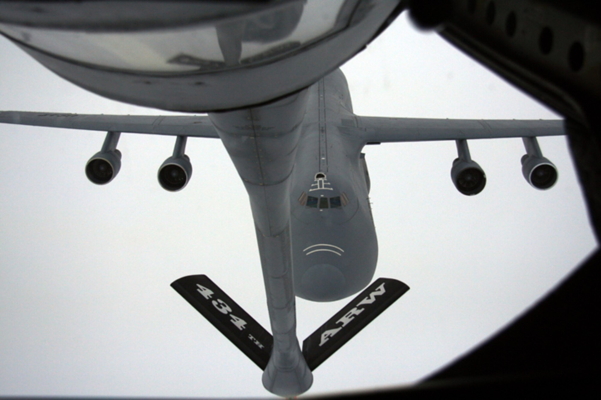 GRISSOM AIR RESERVE BASE, Ind. -- Passing through the clouds, a C-5 Galaxy from the 167th Airlift Wing approaches a KC-135R Stratotanker as it prepares for a mid-air refueling. The C-5 and its crew belong to the West Virginia Air National Guard, and the Stratotanker and its crew are from the 434th Air Refueling Wing.  As the largest KC-135R Stratotanker unit in the Air Force Reserve Command, the 434th ARW maintains a busy schedule refueling fighter, bomber and cargo aircraft.  (U.S. Air Force photo/Staff Sgt. Mark R. W. Orders-Woempner)