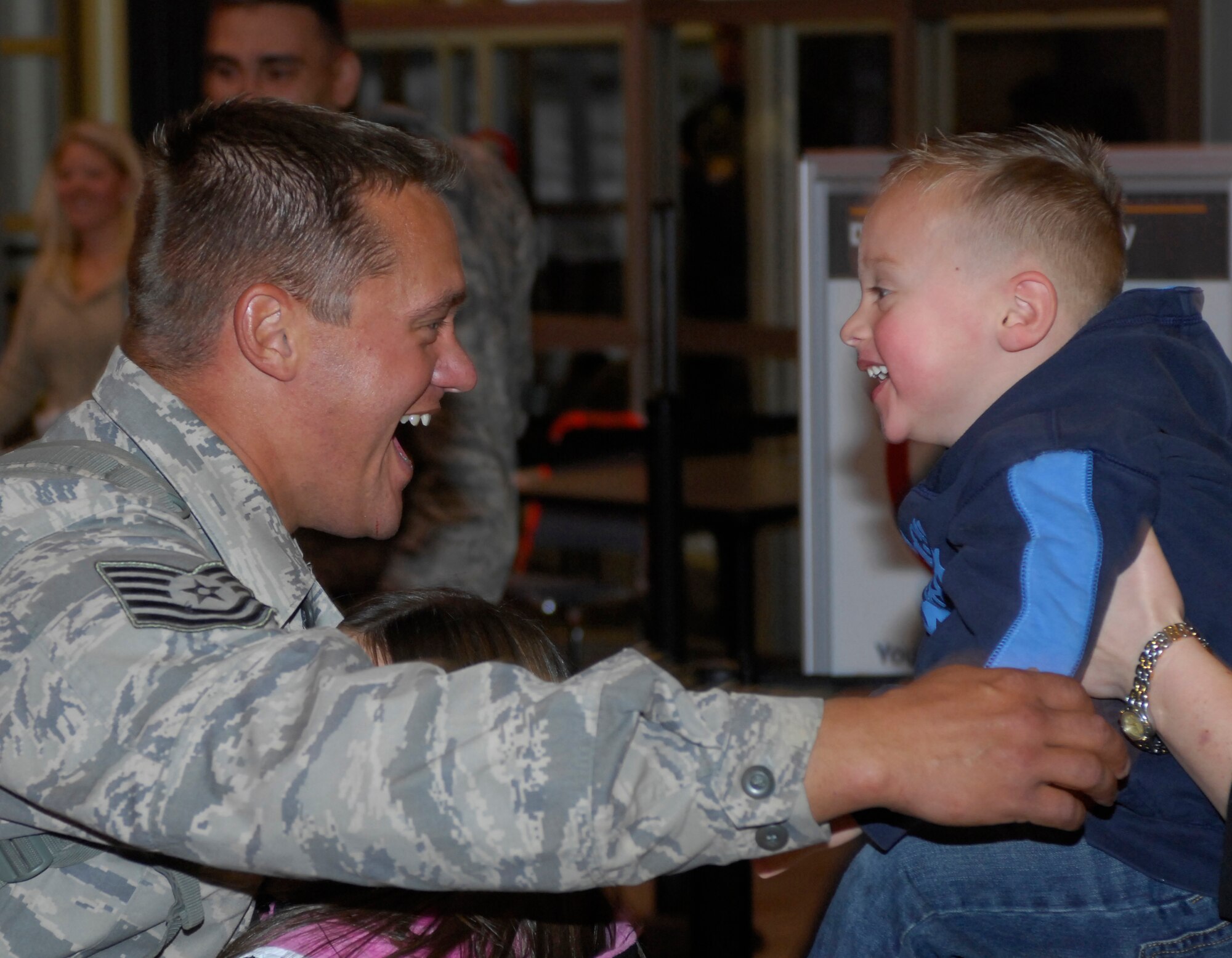 MINOT AIR FORCE BASE, N.D. -- Tech. Sgt. Derron Price, 5th Civil Engineer Squadron pavements and construction equipment craftsman, is greeted by his son Dec. 5 at the Minot International Airport here upon arriving home from a 4-month deployment in support of Continuing Promise.  Continuing Promise is a joint military and civilian endeavor to bring humanitarian relief services to the people of Latin America and the Caribbean. 