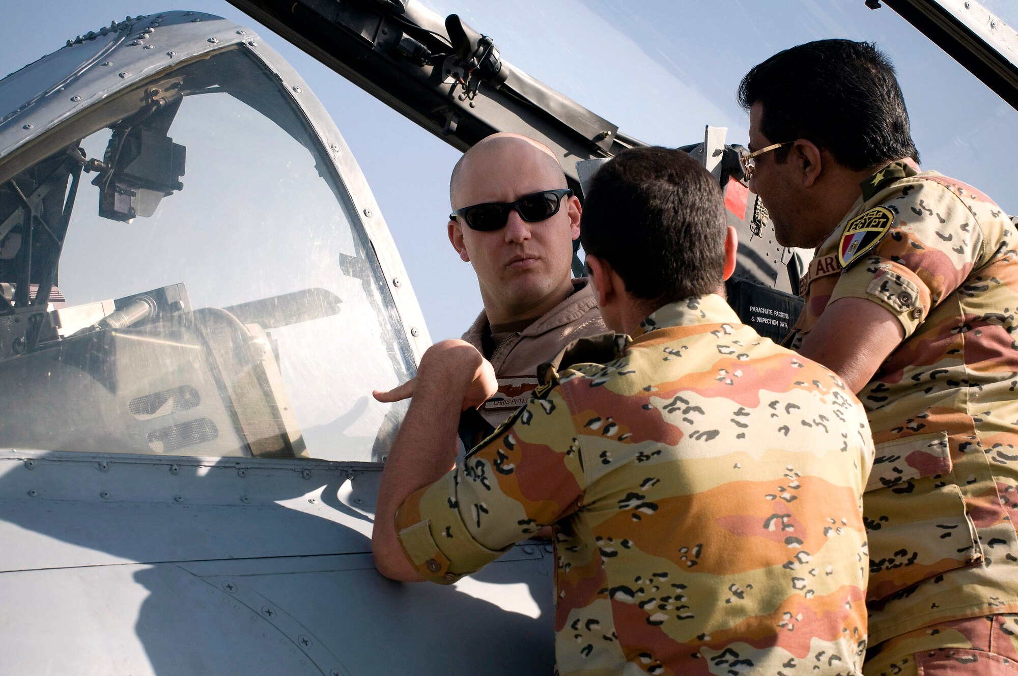 Capt. Chris Petek shows two Egyptian medical personnel the cockpit of an A-10 Thunderbolt II at Bagram Airfield, Afghanistan, Nov. 29. Captain Petek is an A-10 pilot deployed from the 75th Fighter Squadron at Moody Air Force Base, Ga. (U.S. Air Force photo/Staff Sgt. Samuel Morse)