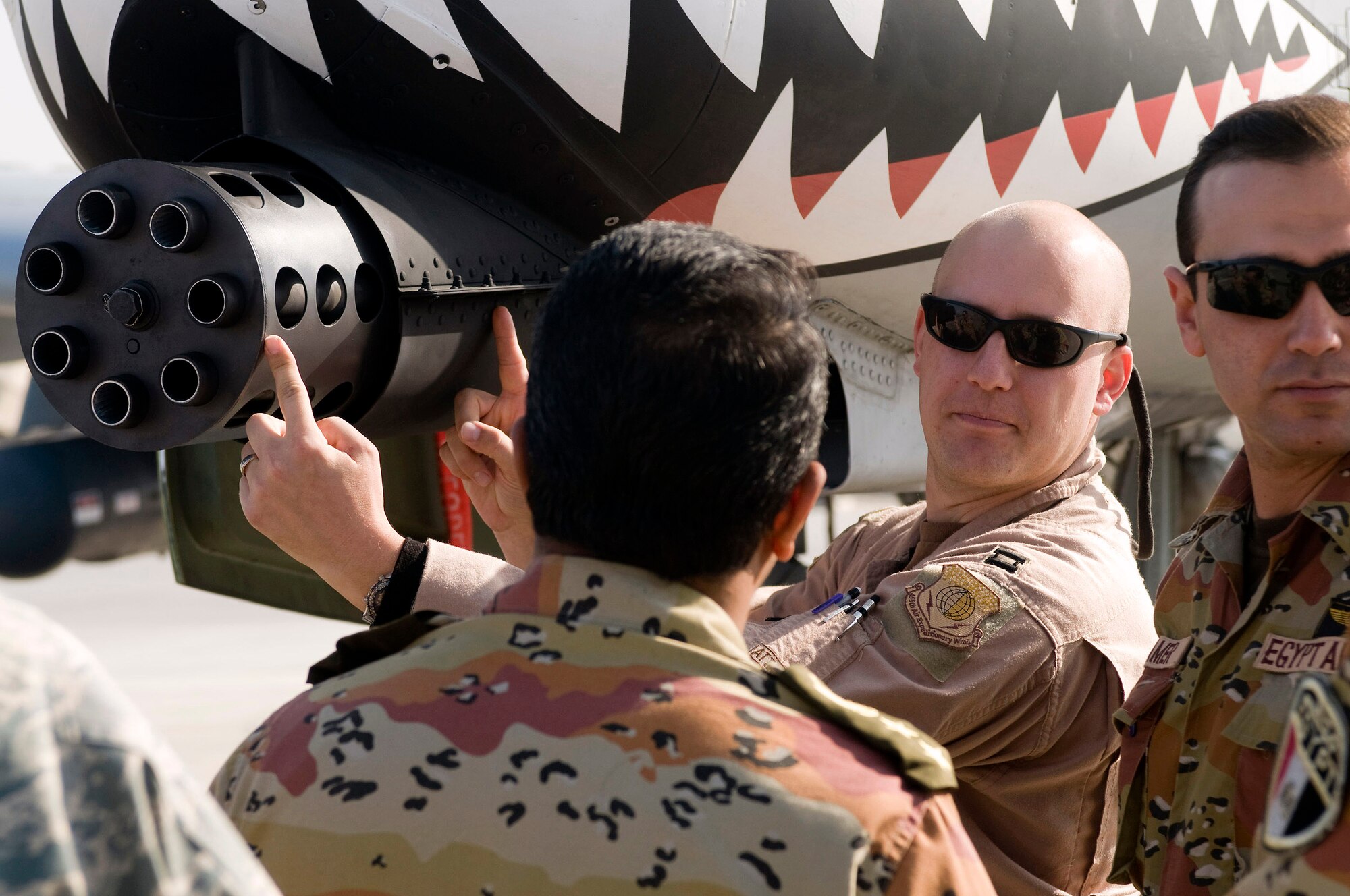 Capt. Chris Petek describes the size of a 30mm round compared to the GAU-8/A "Avenger" 30mm cannon of the A-10 at Bagram Airfield, Afghanistan, Nov. 29. The cannon can fire up to 4,200 PGU-13 30mm high-explosive incendiary rounds per minute and is the backbone of the fighter's armament. Captain Petek is an A-10 pilot deployed from the 75th Fighter Squadron at Moody Air Force Base, Ga. (U.S. Air Force photo/Staff Sgt. Samuel Morse)