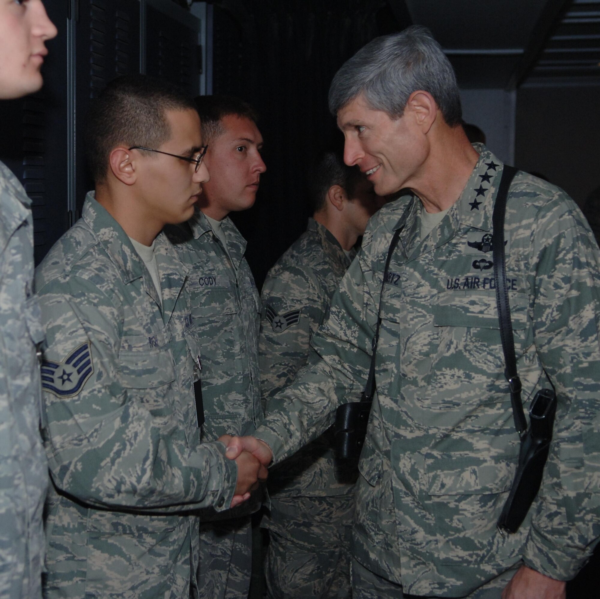 Staff Sgt. Thomas Rich, transmissions systems supervisor, 727 EACS, is coined by Gen. Norton Schwartz, Air Force Chief of Staff for deploying a fifth time in five years.