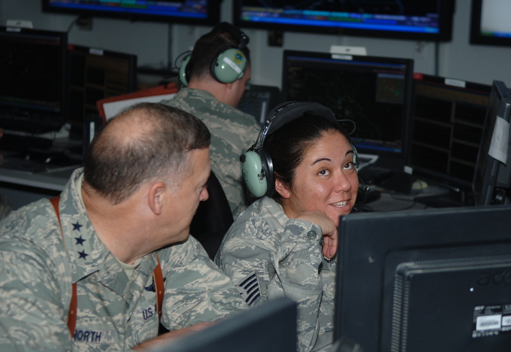 Master Sgt.(s) Jennie Aruda, weapons director, 727 EACS, discusses her role in the CRC with Lt. Gen. Gary North, commander, 9th Air Force during his visit to Joint Base Balad, Iraq.