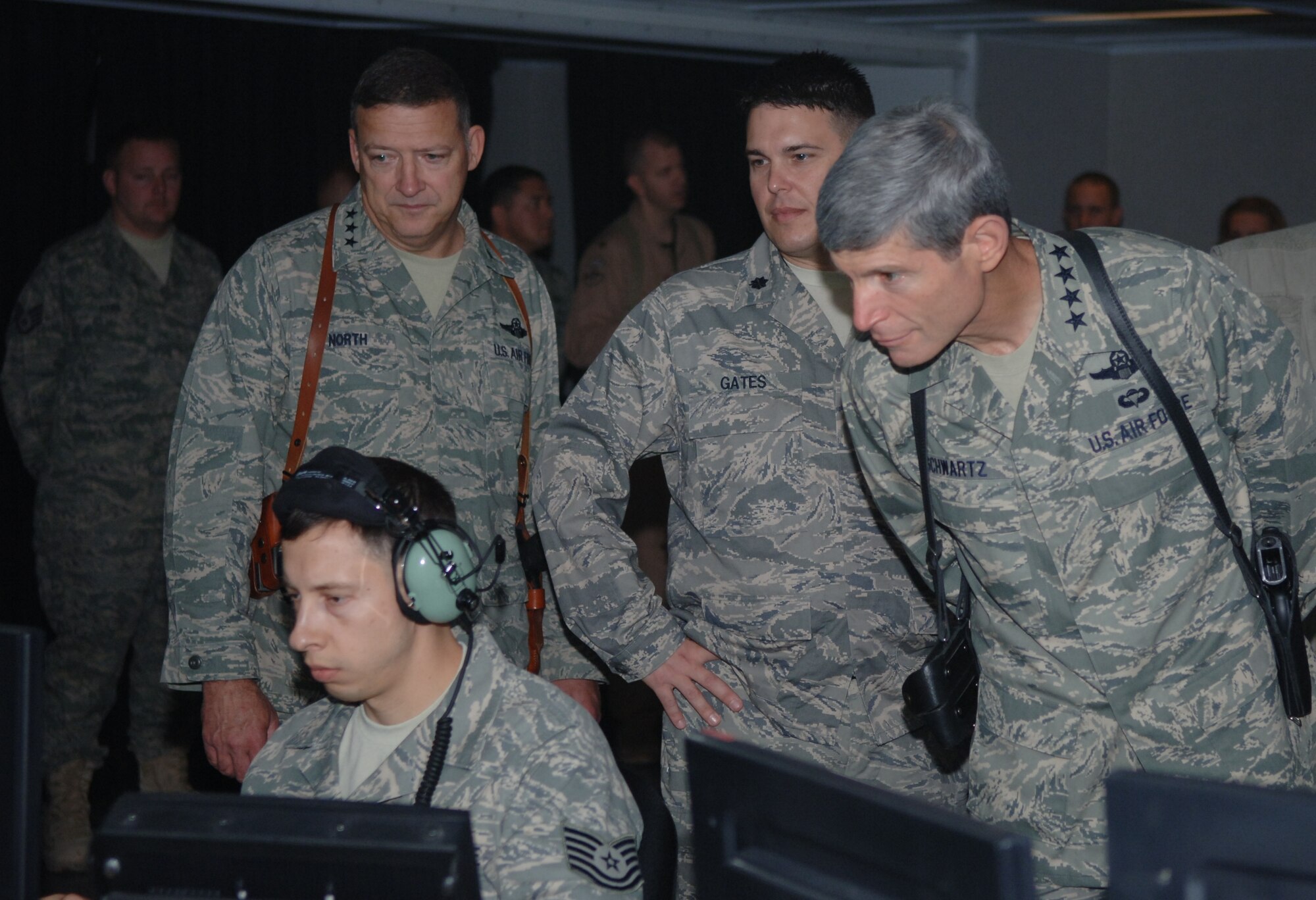 Tech. Sgt. Douglas Lichoff, air surveillance technician, 727 EACS, displays the critical role he plays in the CRC of interpreting radar and IFF codes to identify aircraft in the airspace, as Lt. Gen. Gary North, commander, 9th Air Force, Lt. Col. Bryan Gates, commander, 727 EACS, and Gen. Norton Schwartz, Air Force Chief of Staff look over his shoulder.