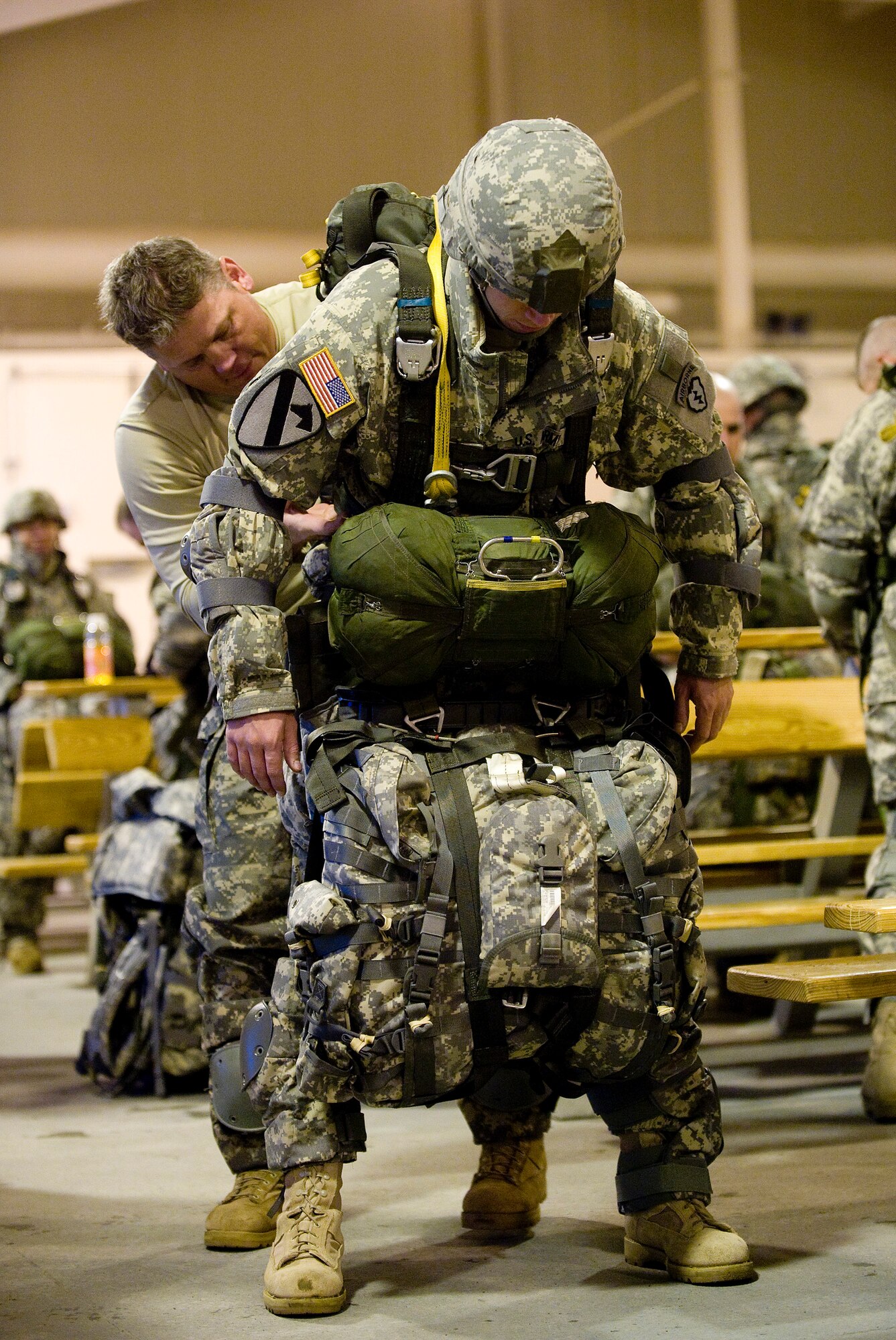 ELMENDORF AIR FORCE BASE, Alaska -- Army Sgt. 1st Class Billy Slagle, 725th Brigade Support Battalion, inspects Capt. Carter Halfman's parachute setup at Joint Mobility Complex Dec. 8. The 4th Brigade Combat Team, 25th Infantry Division partnered with the 517th Airlift Squadron is using this week practice jumps prior to the deployment. Roughly 1,300 4-25 Soldiers will be jumping out of C-17 Globemaster IIIs during the week. (U.S. Air Force photo/Senior Airman Jonathan Steffen)