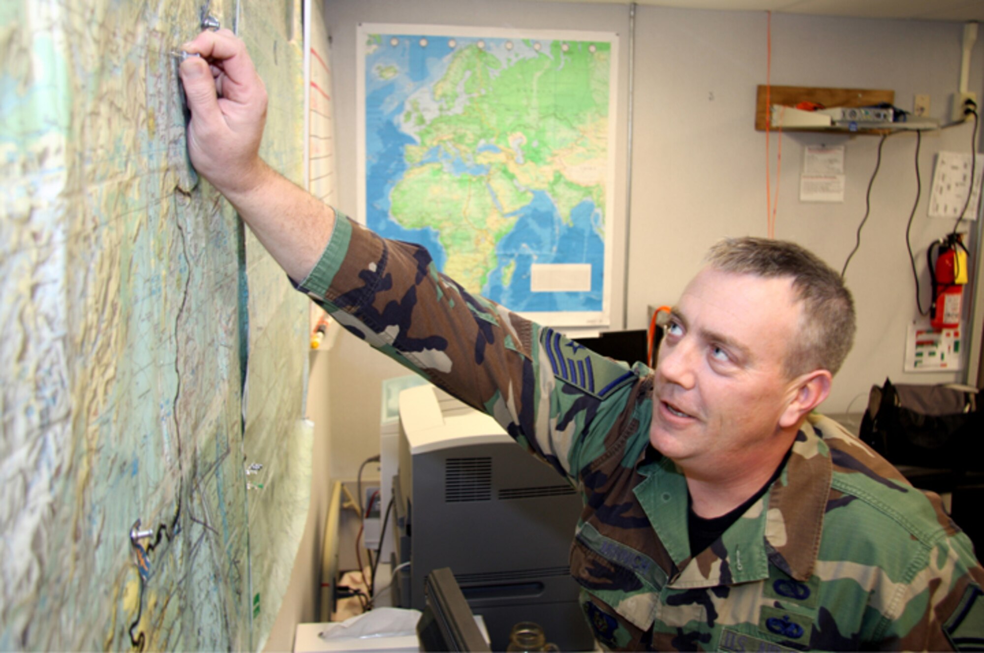 GRISSOM AIR RESERVE BASE, Ind. -- Master Sgt. Greg Minnich, 434th Operations Support Squadron intelligence specialist, pins a specific point on a map while discussing that location during the December unit training assembly here. Sergeant Minnich was recently named 434th Air Refueling Wing Senior Noncommissioned Officer of the Year. The Sergeant said he attributes winning the award to the skills, knowledge and abilities he has learned over the course of several deployments. (U.S. Air Force photo/Staff Sgt. Mark R. W. Orders-Woempner) 