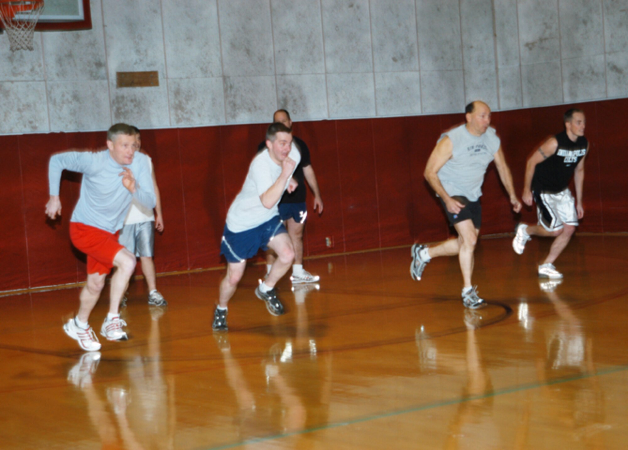 GRISSOM AIR RESERVE BASE, Ind., --  Four participants sprint to the center of the court to begin the recent dodge ball tournament at Grissom.  The four were trying to be the first to reach the dodge balls and launch a salvo at their opposition.  (U.S. Air Force photo/Staff Sgt. Ben Mota)                                 
