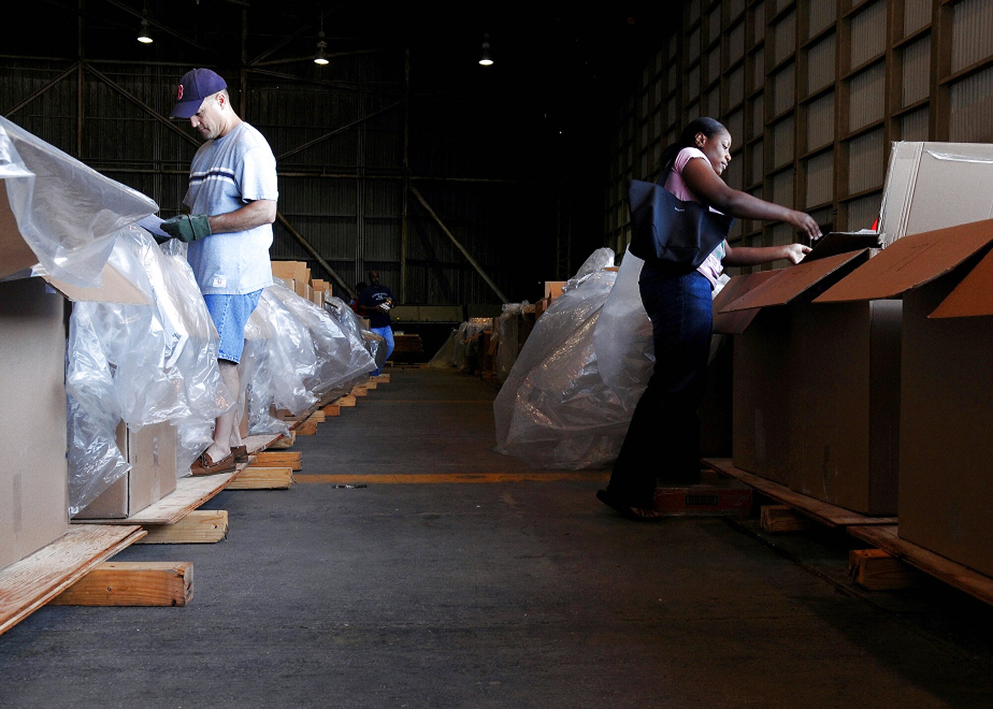 Chief Master Sgt. James Cornell (left) and Staff Sgt. Lishey Brown pack boxes for Operation Christmas Drop 2008 at Andersen Air Force Base, Guam. The organization has received ten of thousands of donations and more than $30,000 in sponsorships. Chief Cornell is the 36th Maintenance Group Superintendent. Sergeant Brown is assigned to the 36th Force Support Squadron retirements and separations section. (U.S. Air Force photo/Senior Airman Nichelle Griffiths)