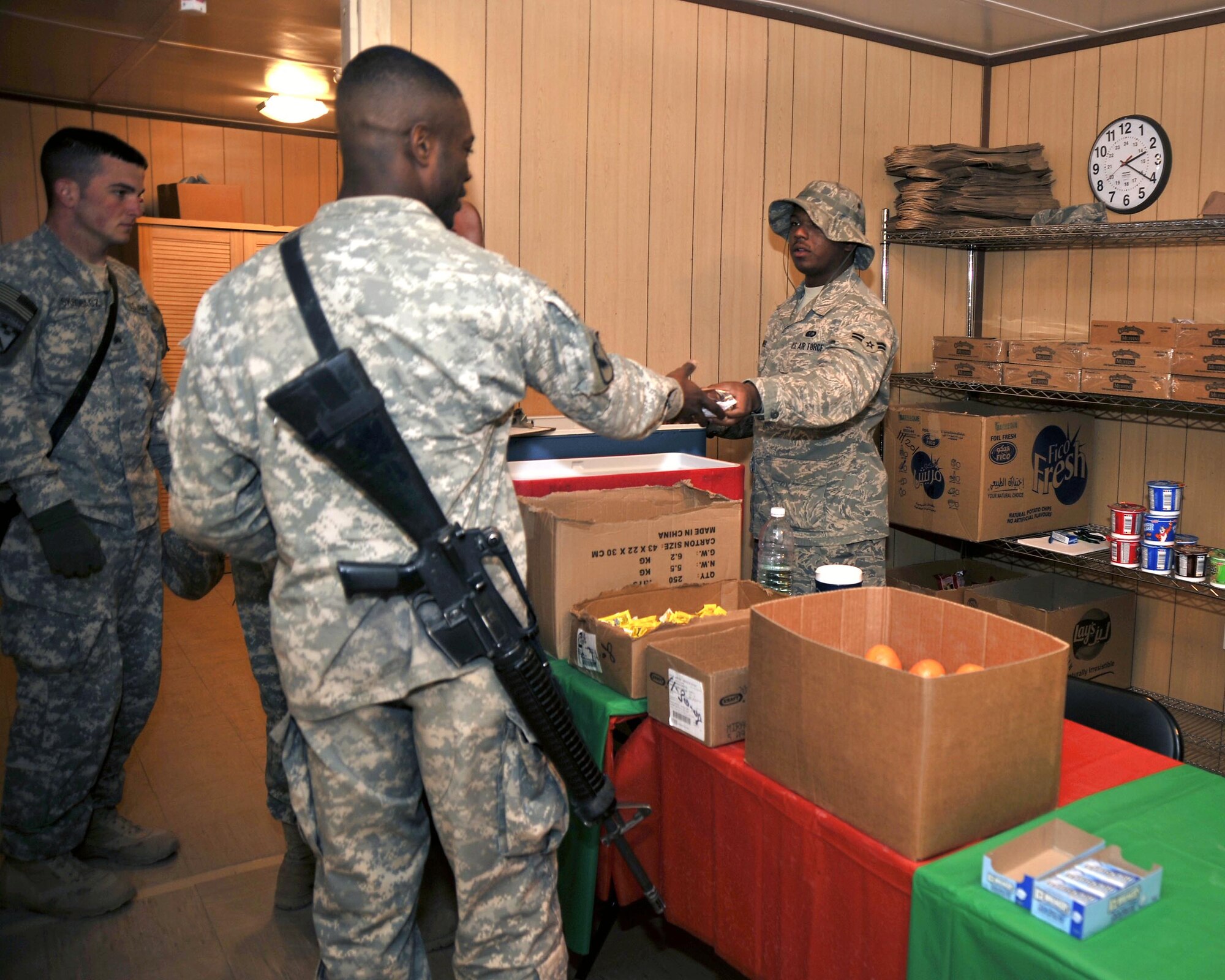 Airman 1st Class Justin Harris serves sandwiches and other snacks to servicemembers awaiting flights at Sather Air Base, Iraq.  Airman Harris is a food services journeyman assigned to the 447th Expeditionary Force Support Squadron and is deployed from the 100th Force Support Squadron, RAF Mildenhall, England. (U.S. Air Force photo/Master Sgt. Brian Davidson)