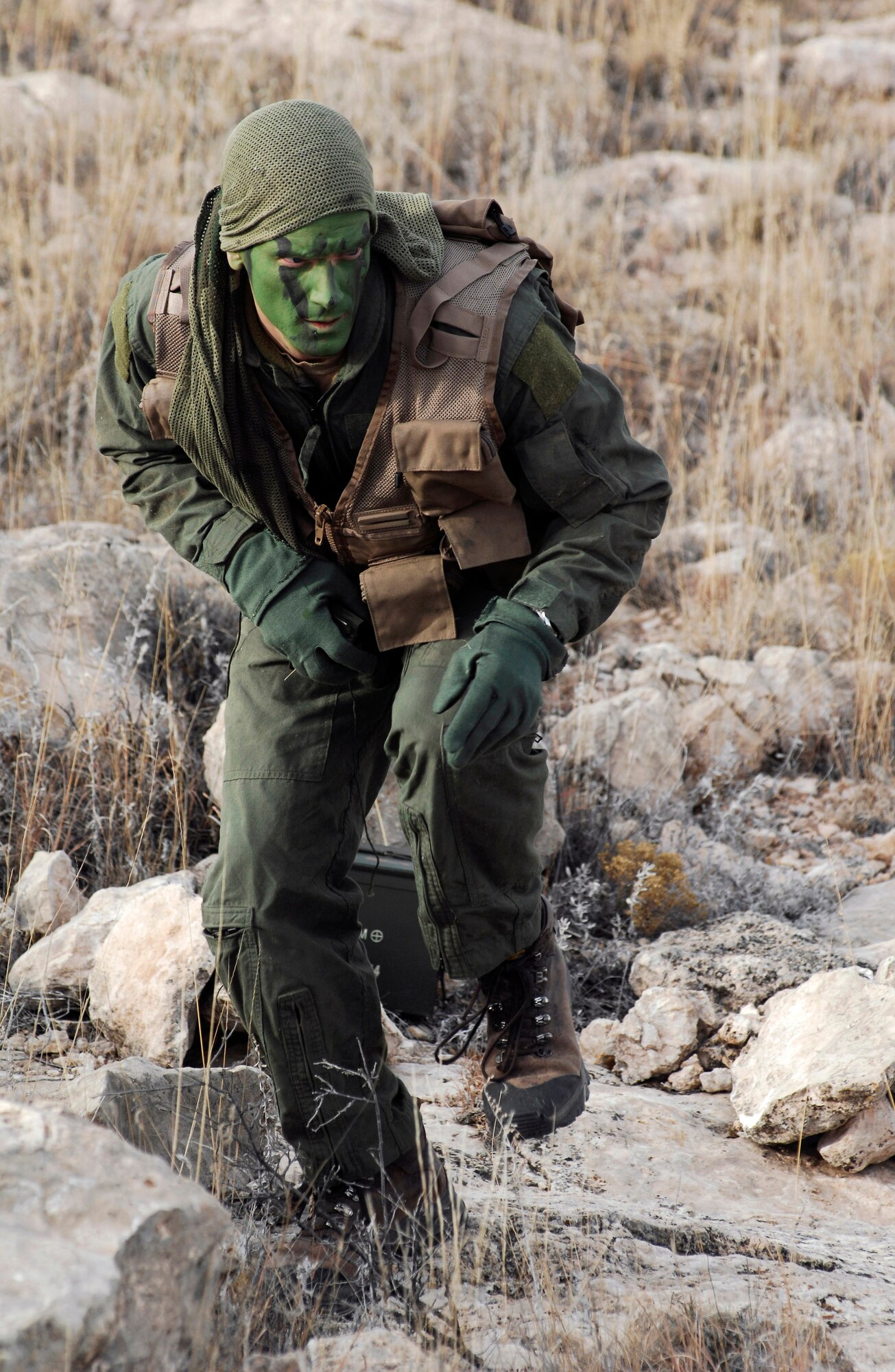 CANNON AIR FORCE BASE, N.M. -- Tech. Sgt. Anthony Proctor, a 27th Special Operations Support Squadron Survival Evasion Resistance Escape program instructor, demonstrates the first three of five phases of evasion during Code of Conduct Continuation Training. Students were required to traverse the range using an array of tools and make it to a predetermined rendezvous point where special operations forces took them to safety. (U.S. Air Force photo/Airman 1st Class Danielle Martin)