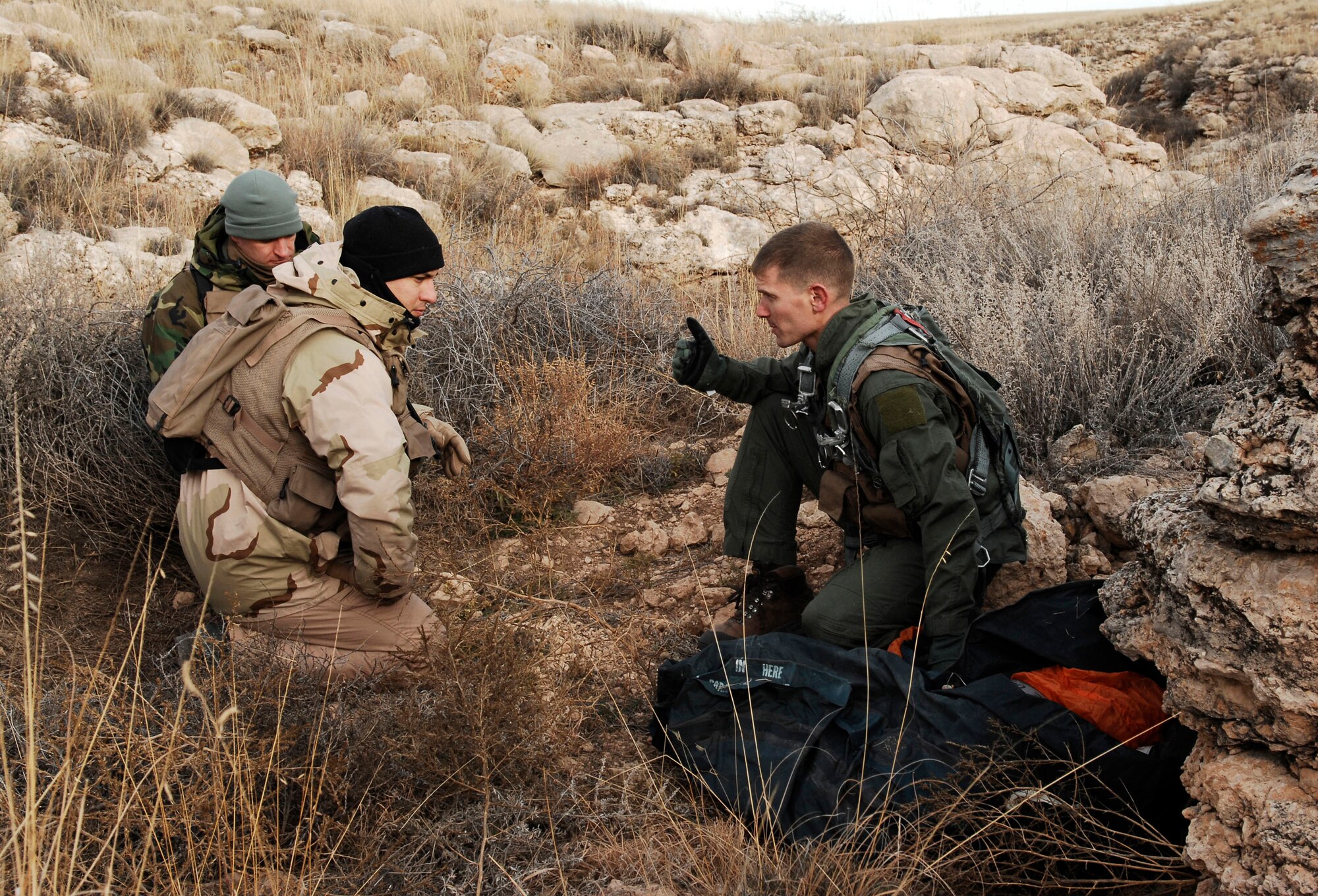 CANNON AIR FORCE BASE, N.M. - (right) Tech. Sgt. Anthony Proctor, 27th Special Operations Support Squadron, demonstrates the first three of five phases of evasion during Code of Conduct Continuation Training, which is a part of the Air Force Survival Evasion Resistance Escape program. The Air Force SERE program encompasses Code of Conduct Training, CoCCT, and Personnel Recovery. SERE is part of the Guardian Angel Weapons System which also includes Combat Rescue officers and Pararescuemen. (U.S. Air Force photo/Airman 1st Class Danielle Martin)