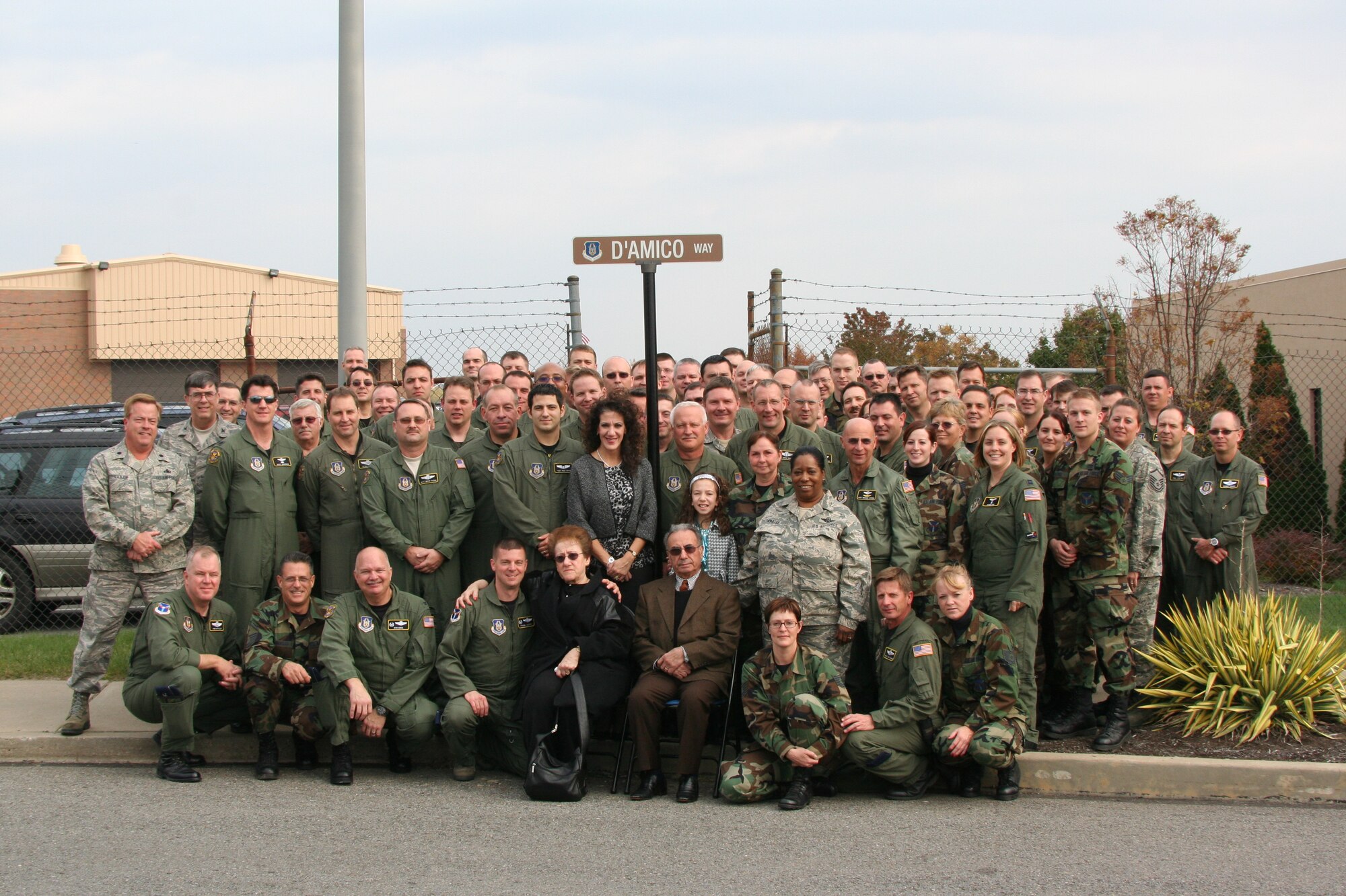 Lisa and Natalie D'amico, wife and daughter of Master Sgt. Robert L. D'amico,
(center) stand with 911th Air Lift Wing command personnel beneath a street
sign dedicated to Master Sgt. D'amico during a ceremony here Nov. 1. Master
Sgt. D'amico, a former loadmaster with the 758th Airlift Squadron, 911th Airlift
Wing, and civilian employee, passed away on Sep. 22 after a long battle with
cancer. Master Sgt. D'amico's integrity and dedication to duty made him a
cherished member of the 911th's family. (photo by Tech Sgt. Ian Carrier)
